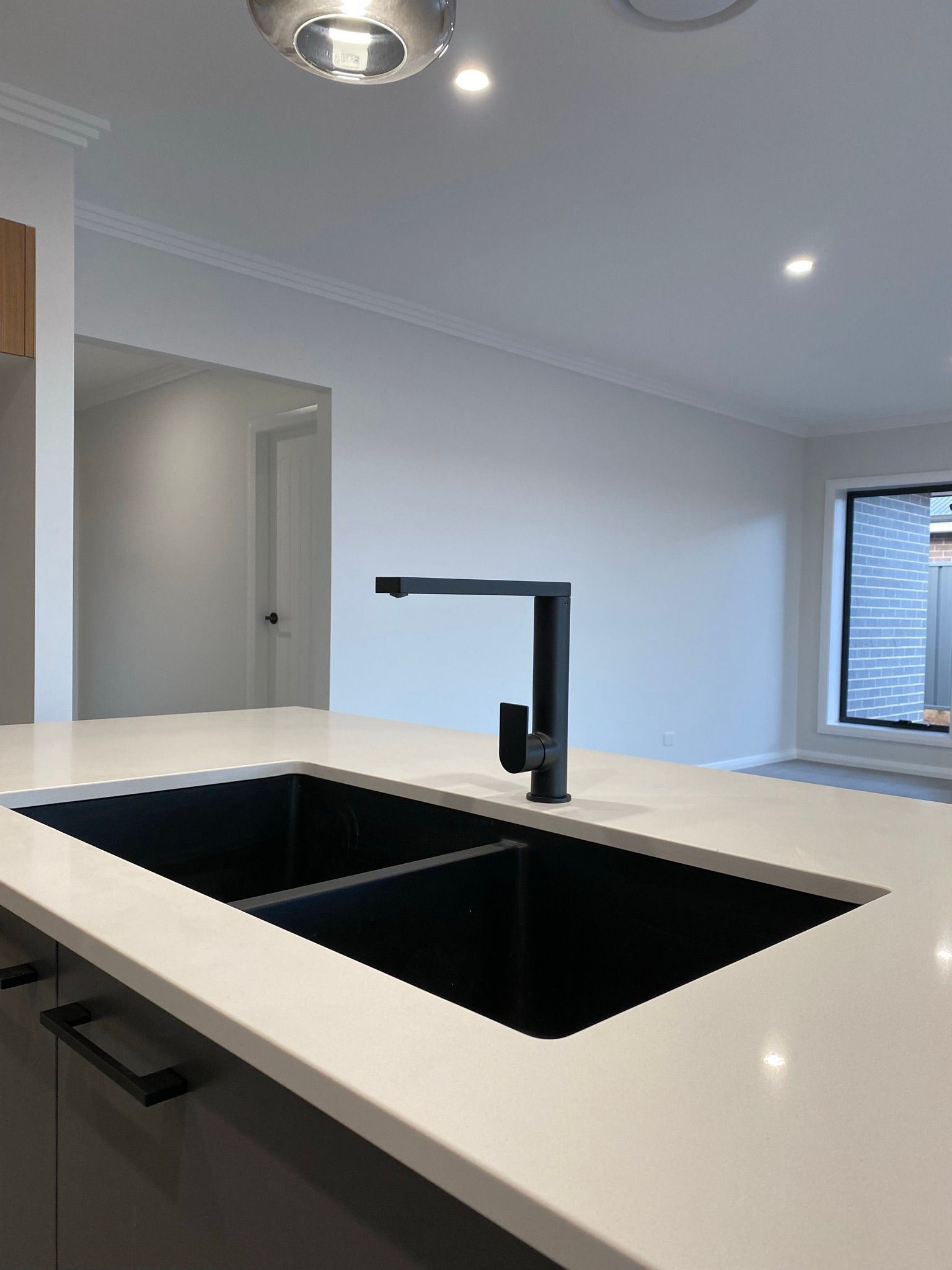 Black Kitchen Sink and Tap Water in The Kitchen — Kitchen Renovations in Dubbo, QLD