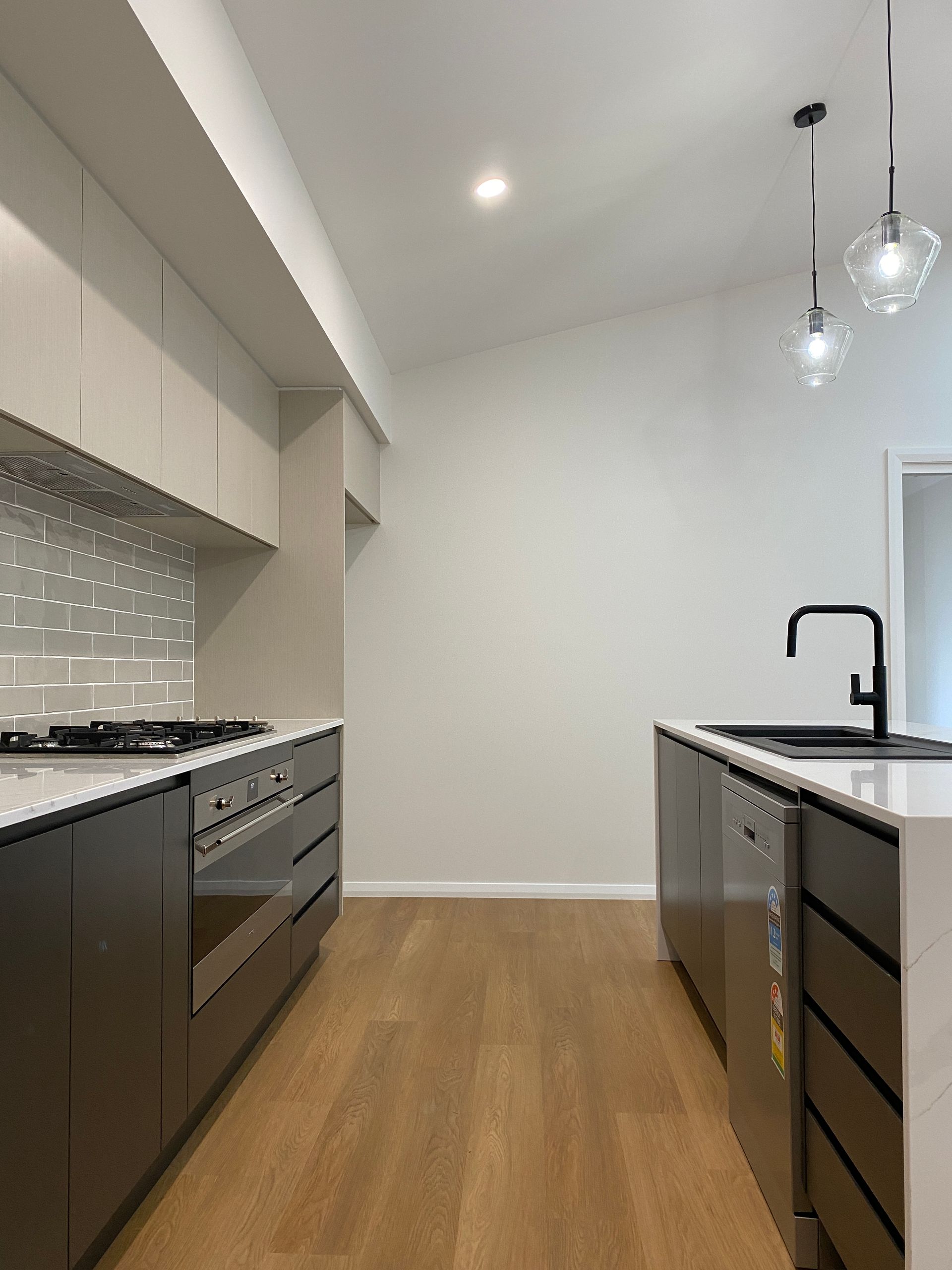 Kitchen Hallway With Black Cabinets — Kitchen Renovations in Dubbo, QLD