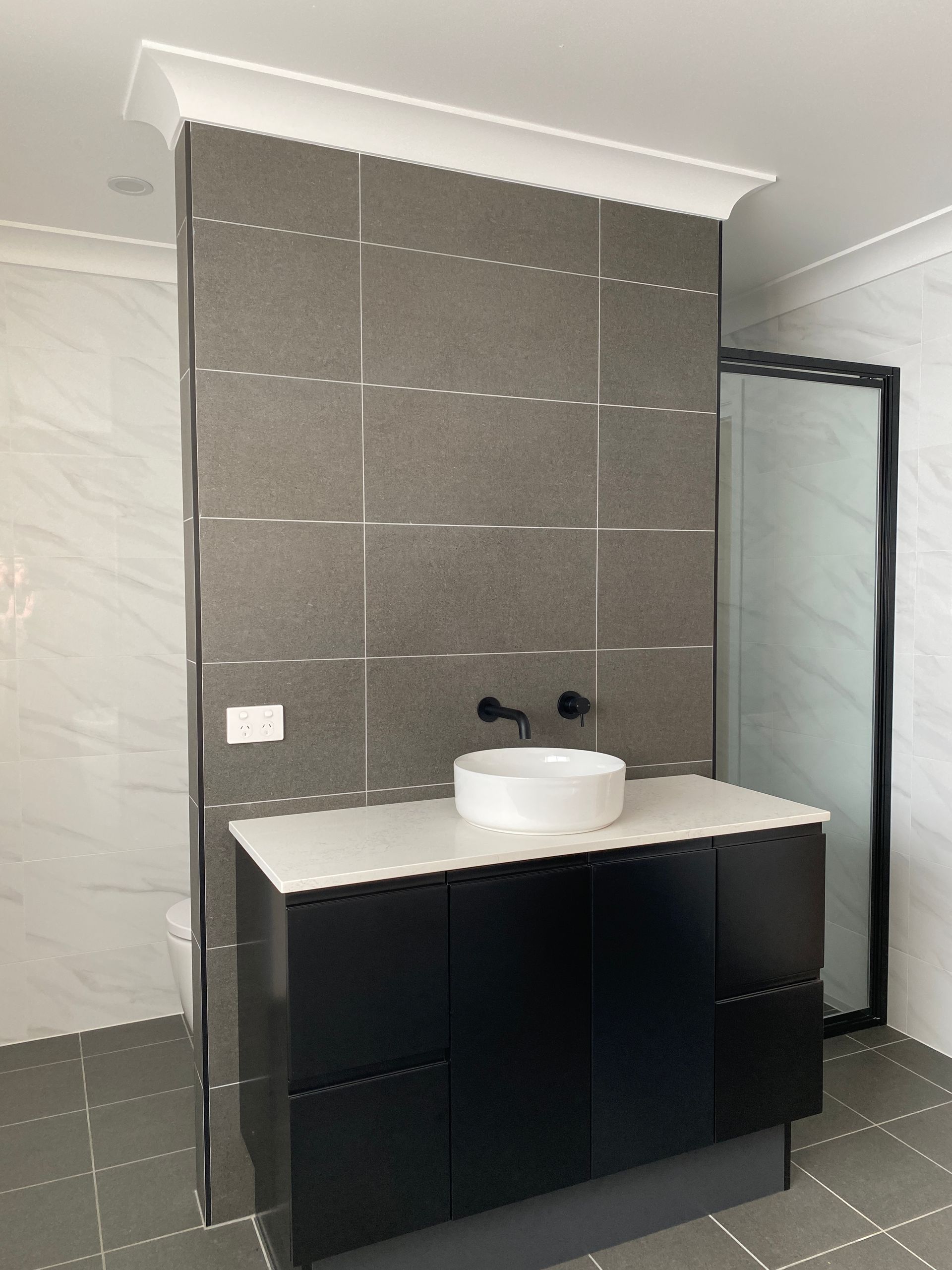 Washbasin With Grey Tiles and Black Cabinets — Kitchen Renovations in Dubbo, QLD