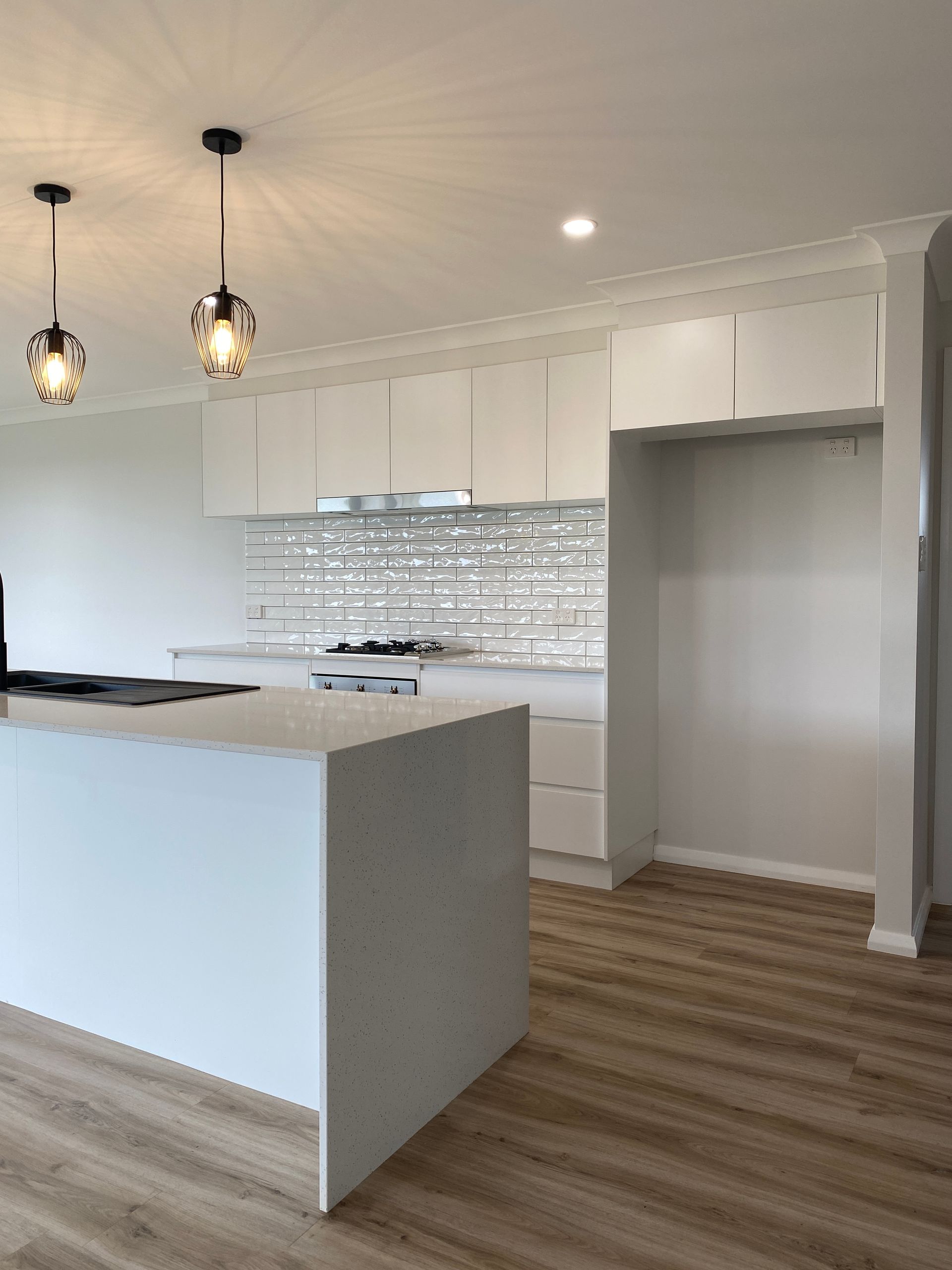 White Kitchen With Modern Subway Tiles — Kitchen Renovations in Dubbo, QLD