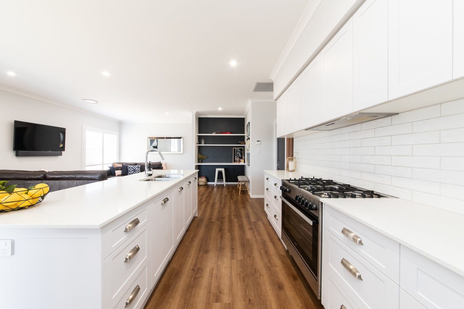 White Kitchen Cabinets And Wooden Floor — Kitchen Renovations in Dubbo, QLD