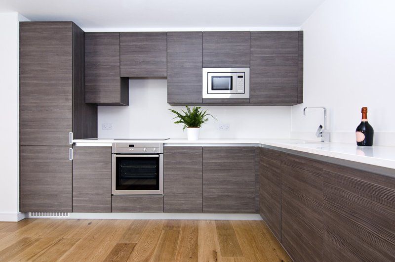 Modern Kitchen With Grey Cabinets — Kitchen Renovations in Orange, QLD