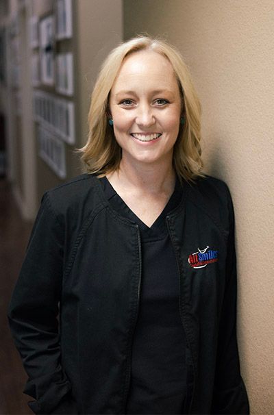 A woman wearing a black jacket with the name ashley on it