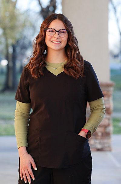 A woman wearing a black jacket with the name ashley on it