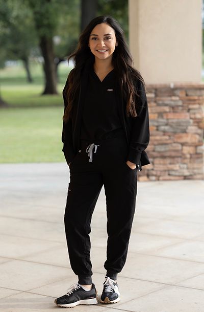 A woman wearing a black jacket with the name ashley on it