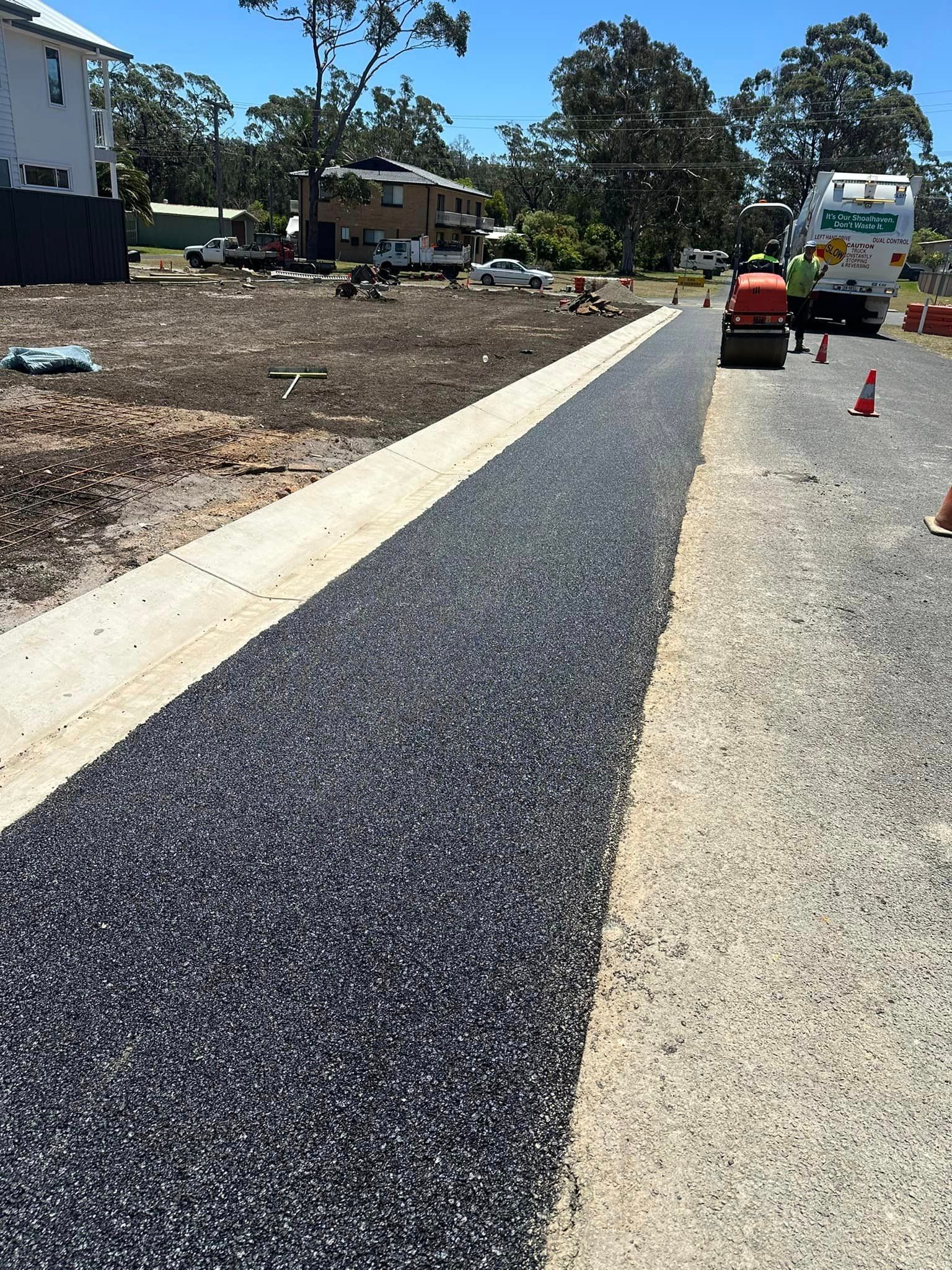 A road is being paved in a residential area.
