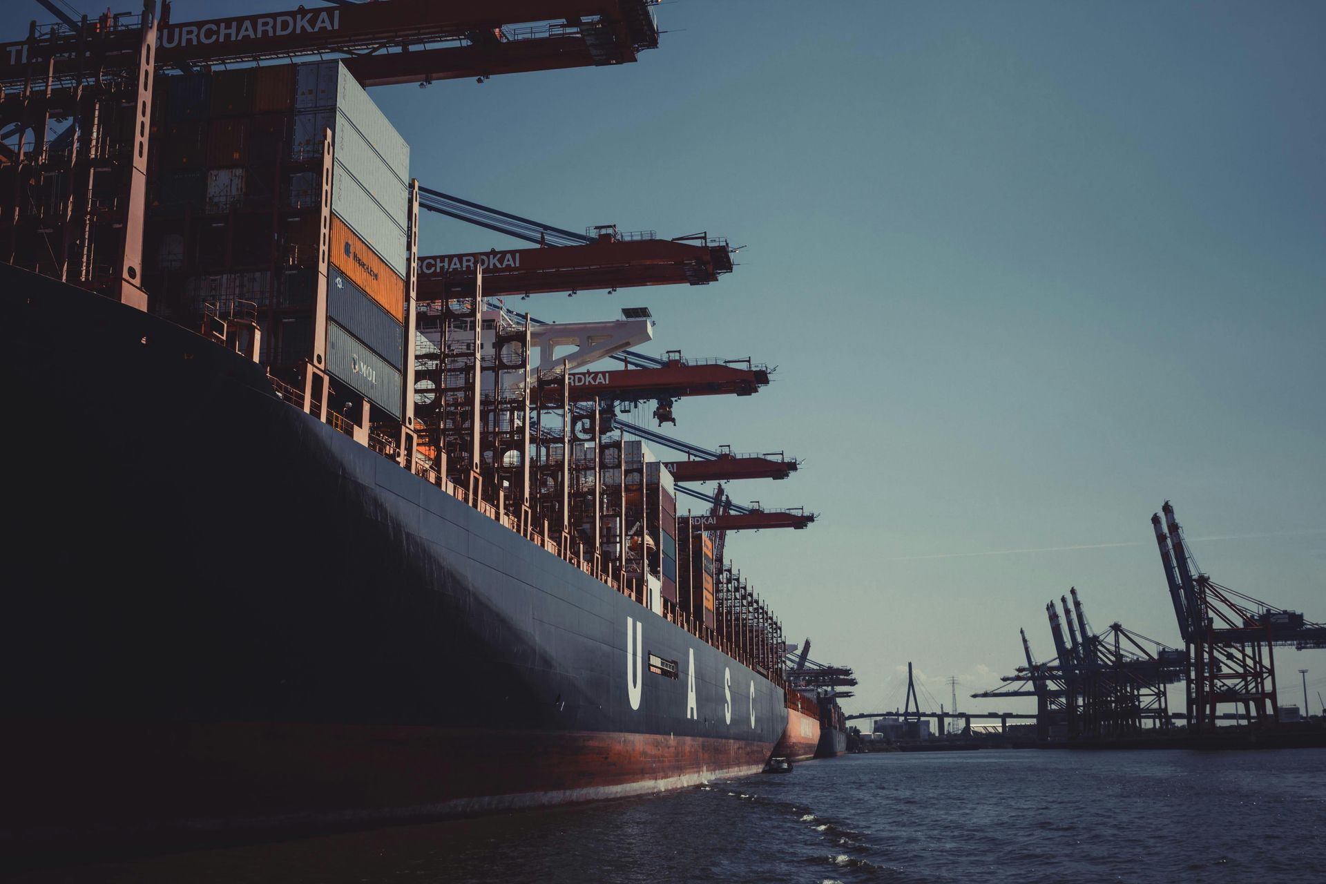 A row of maersk shipping containers are stacked on top of each other