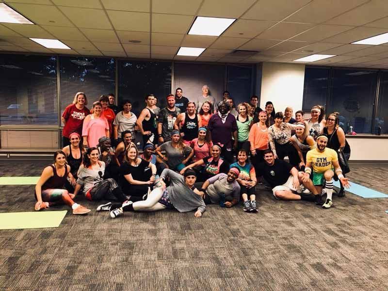 A group of people are posing for a picture in a room.