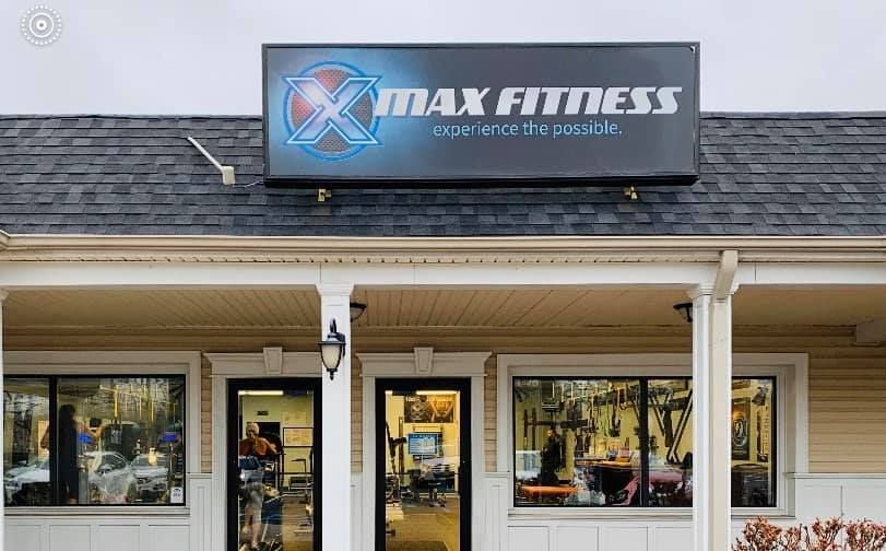 The front of a gym with a sign that says 