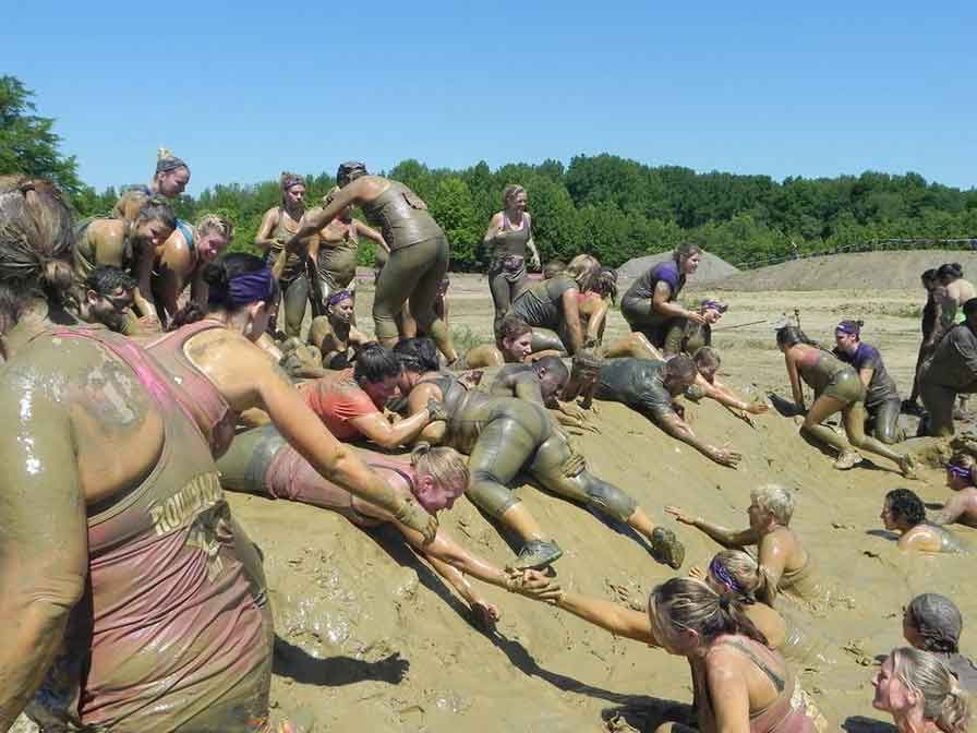 A group of people are playing in the mud.