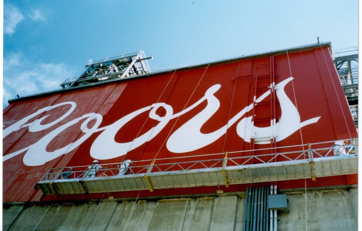 a living room with a blue couch and two paintings on the wall .