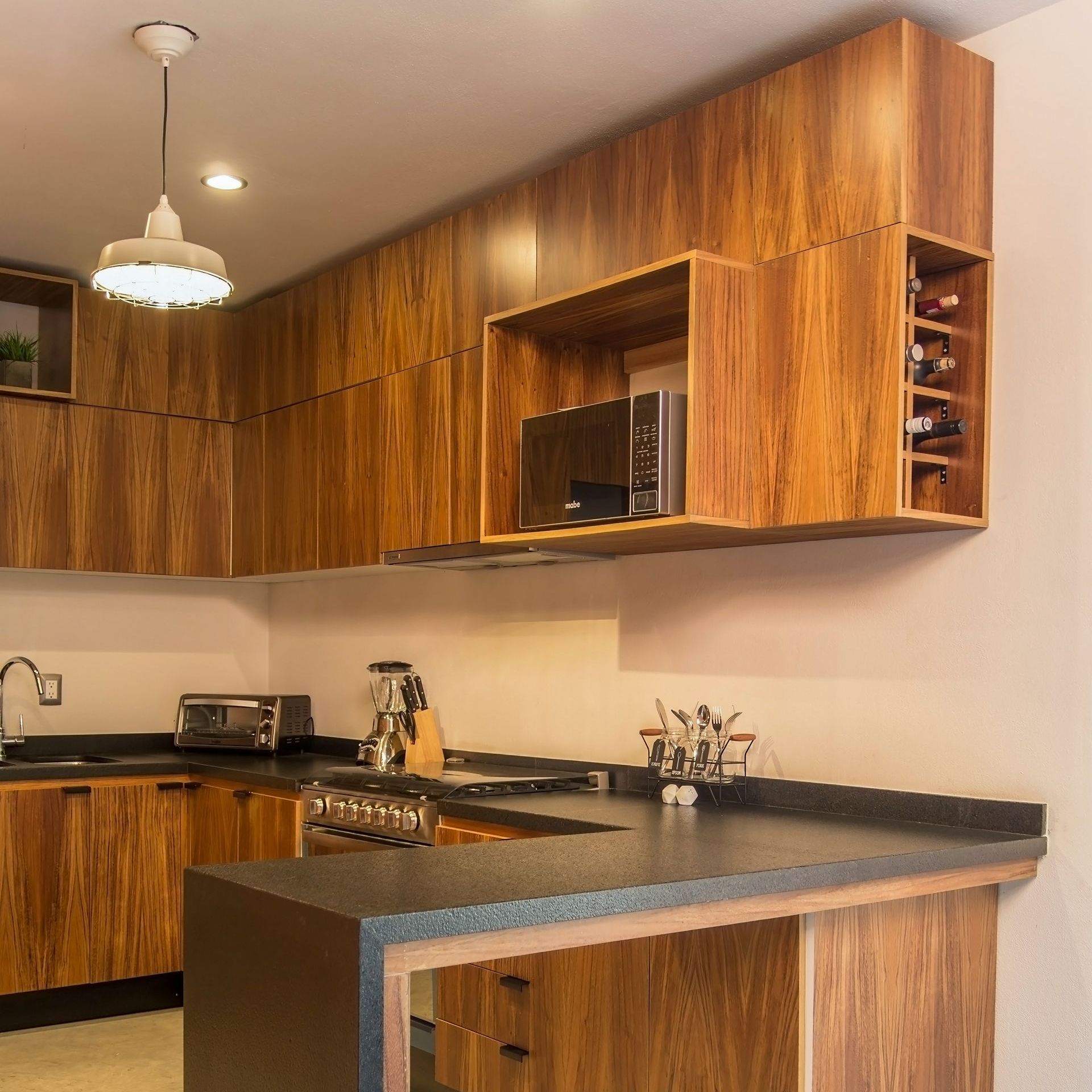 a kitchen with wooden cabinets and a wine rack