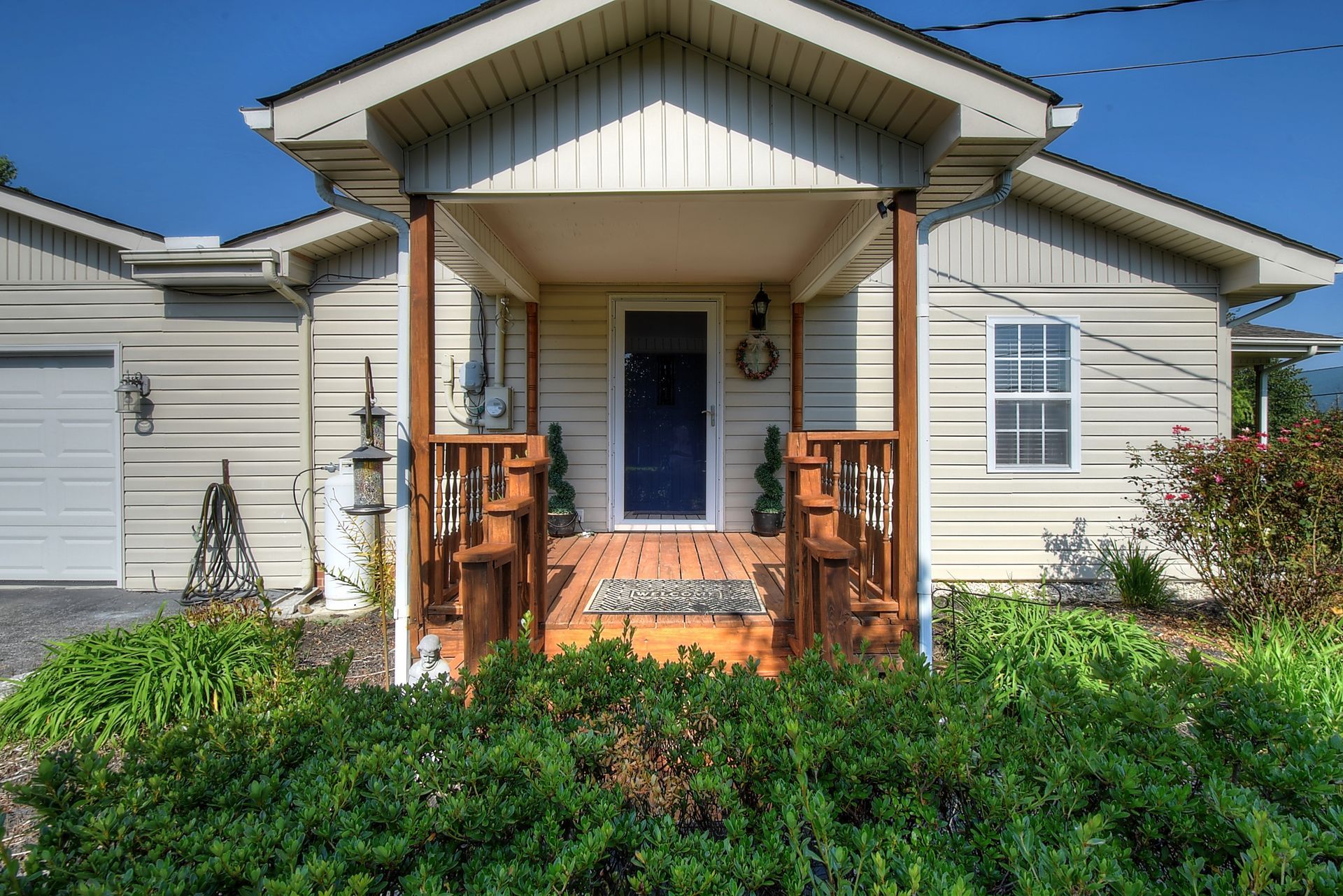A white house with a porch and a garage