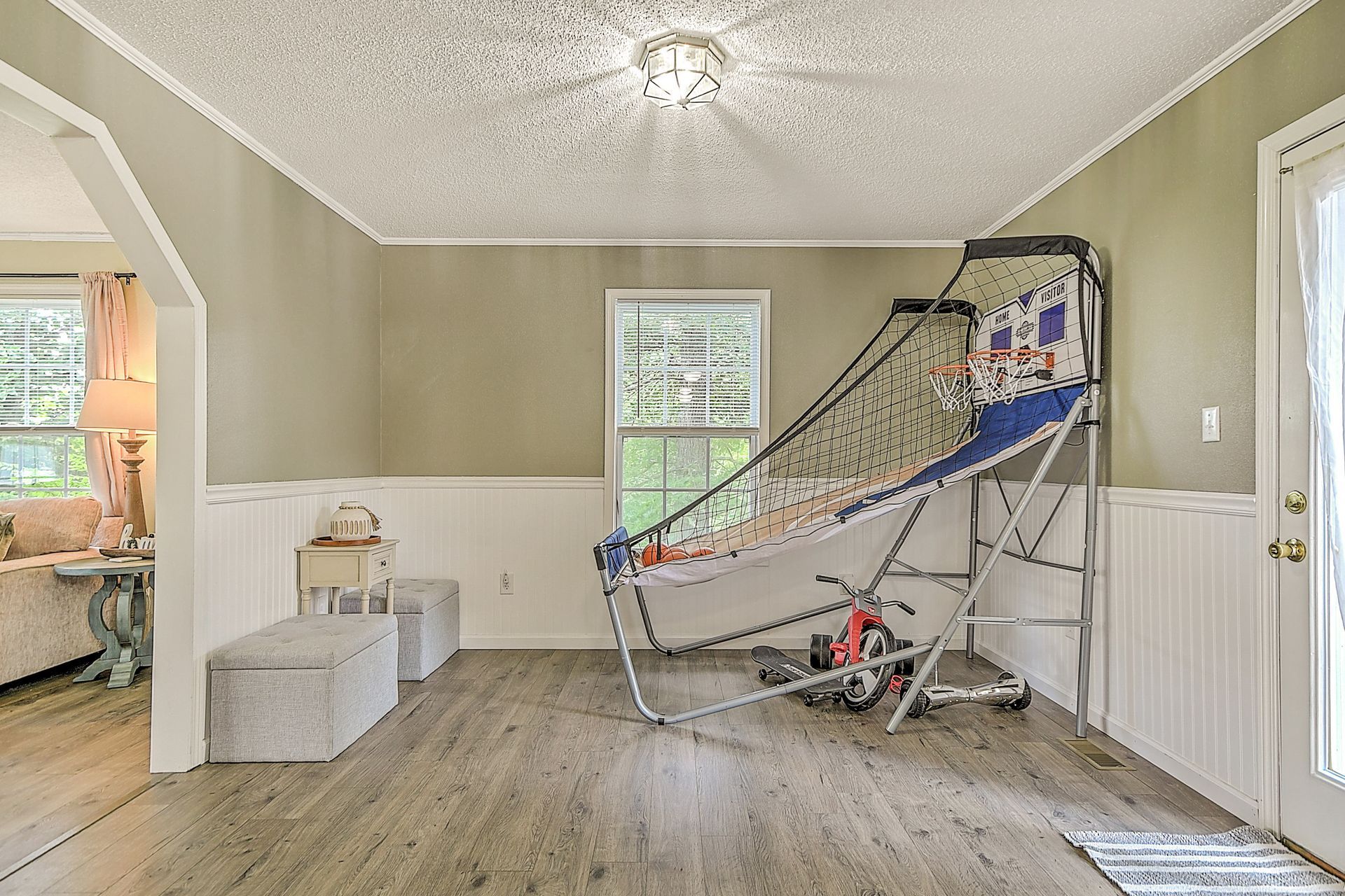 There is a basketball hoop in the middle of the room.