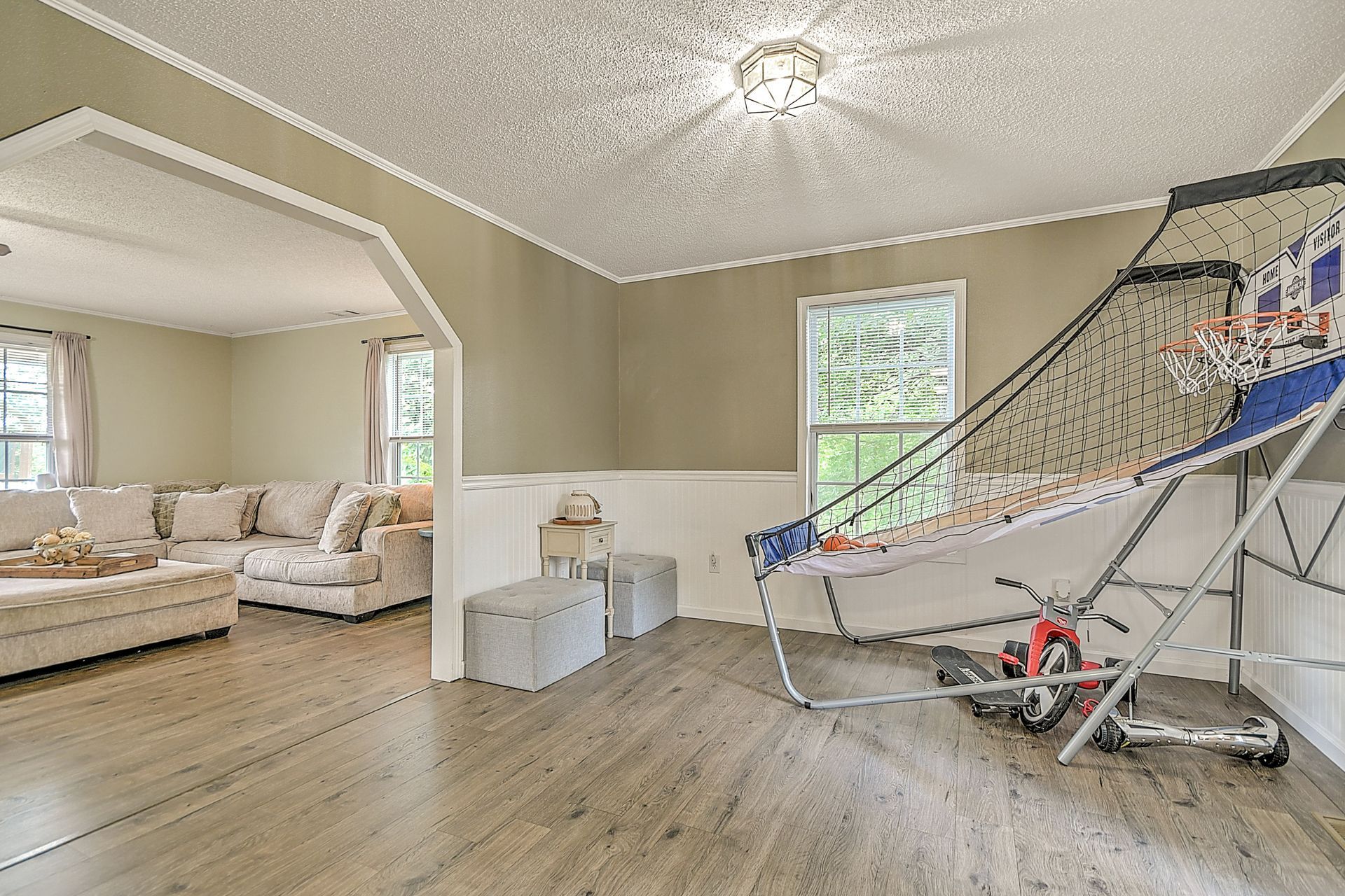 There is a basketball hoop in the middle of the living room.