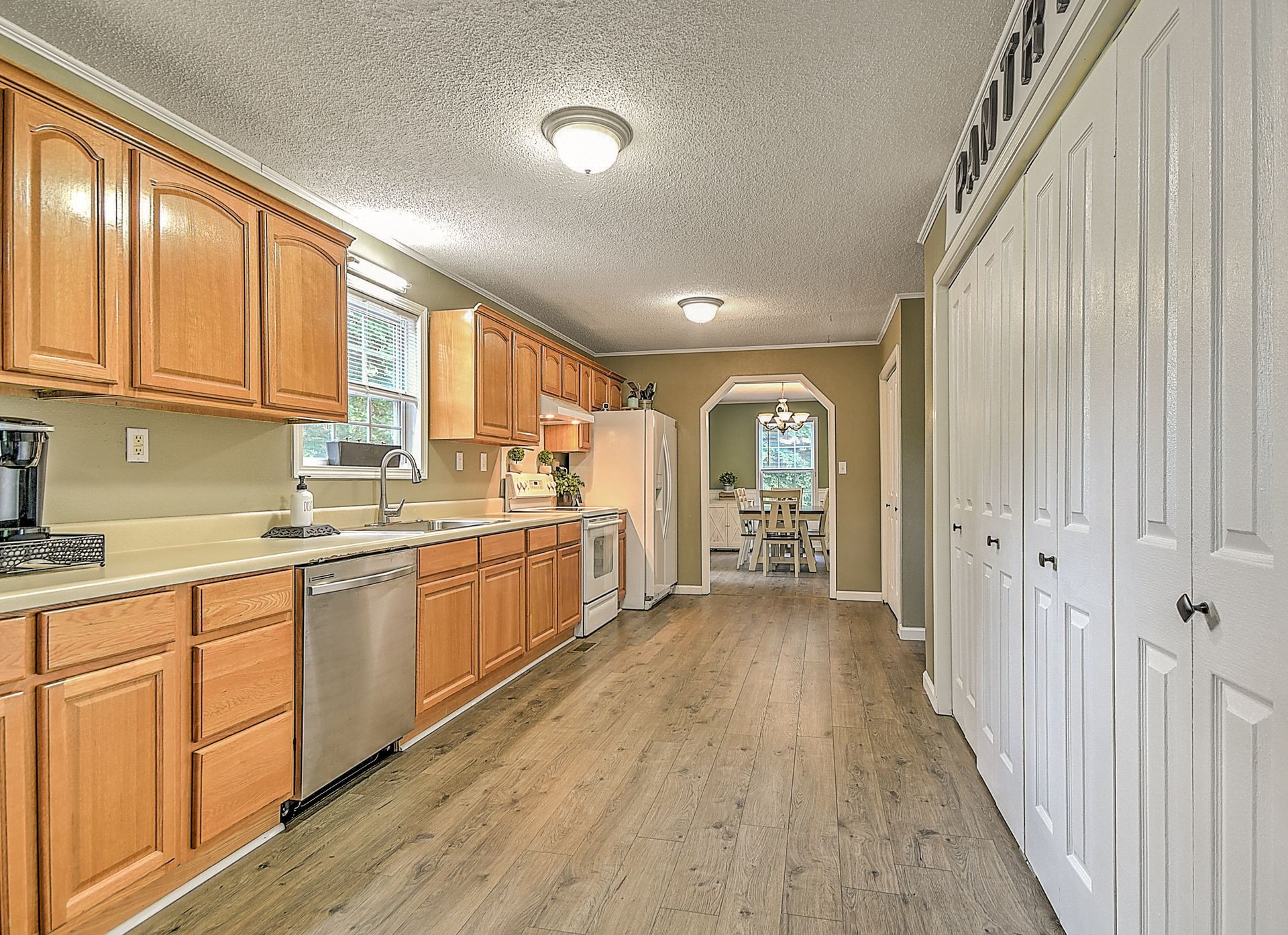 A kitchen with wooden cabinets and stainless steel appliances