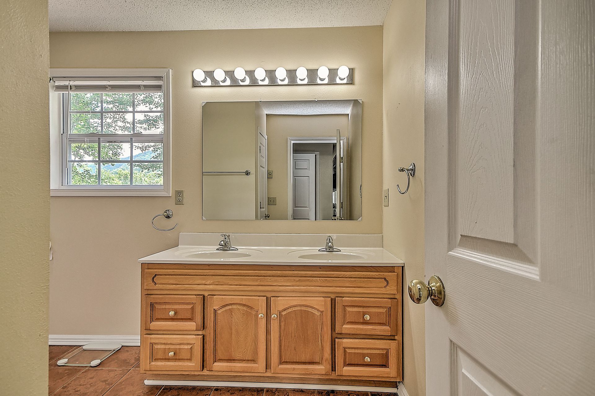 A bathroom with two sinks and a large mirror