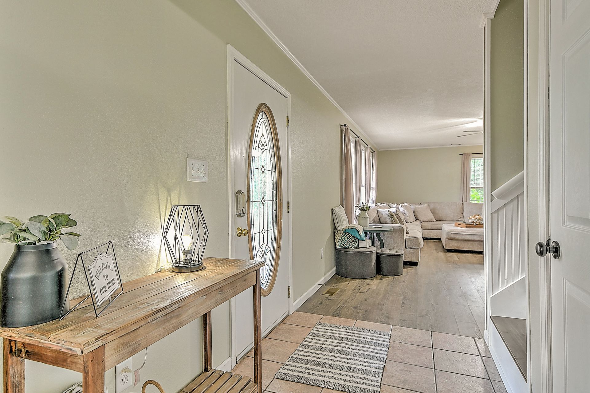 A hallway in a house with a wooden table in the middle.