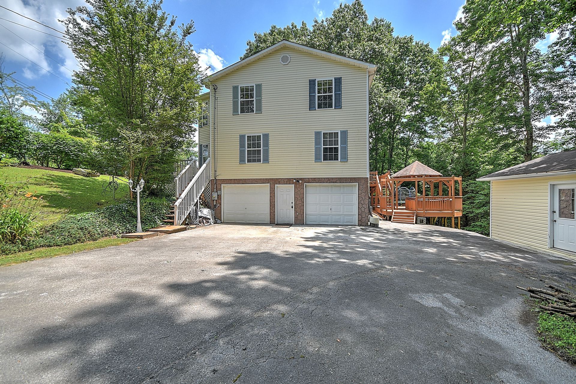 A large house with two garages and a deck is for sale.
