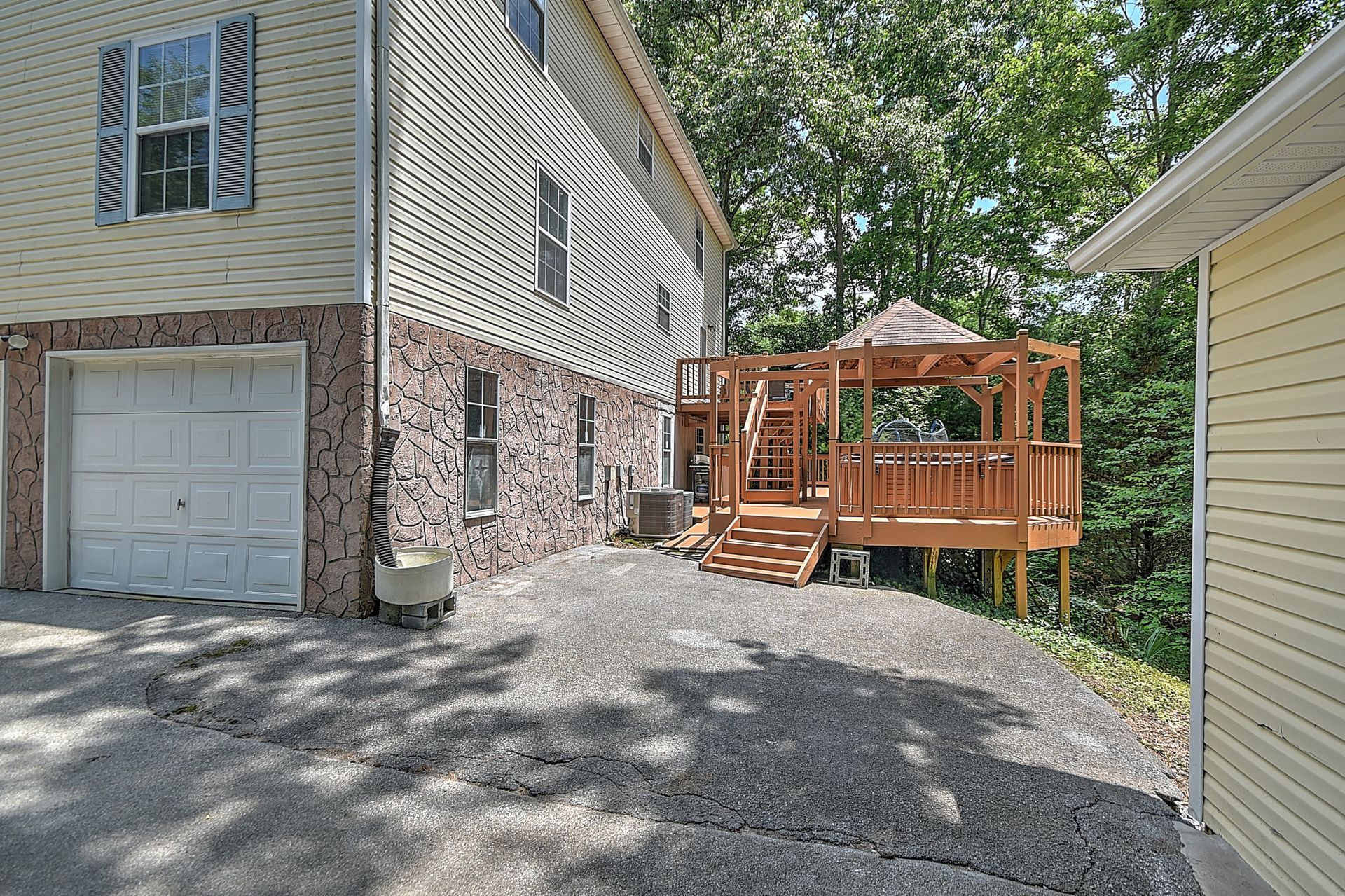 A house with a garage and a deck in front of it