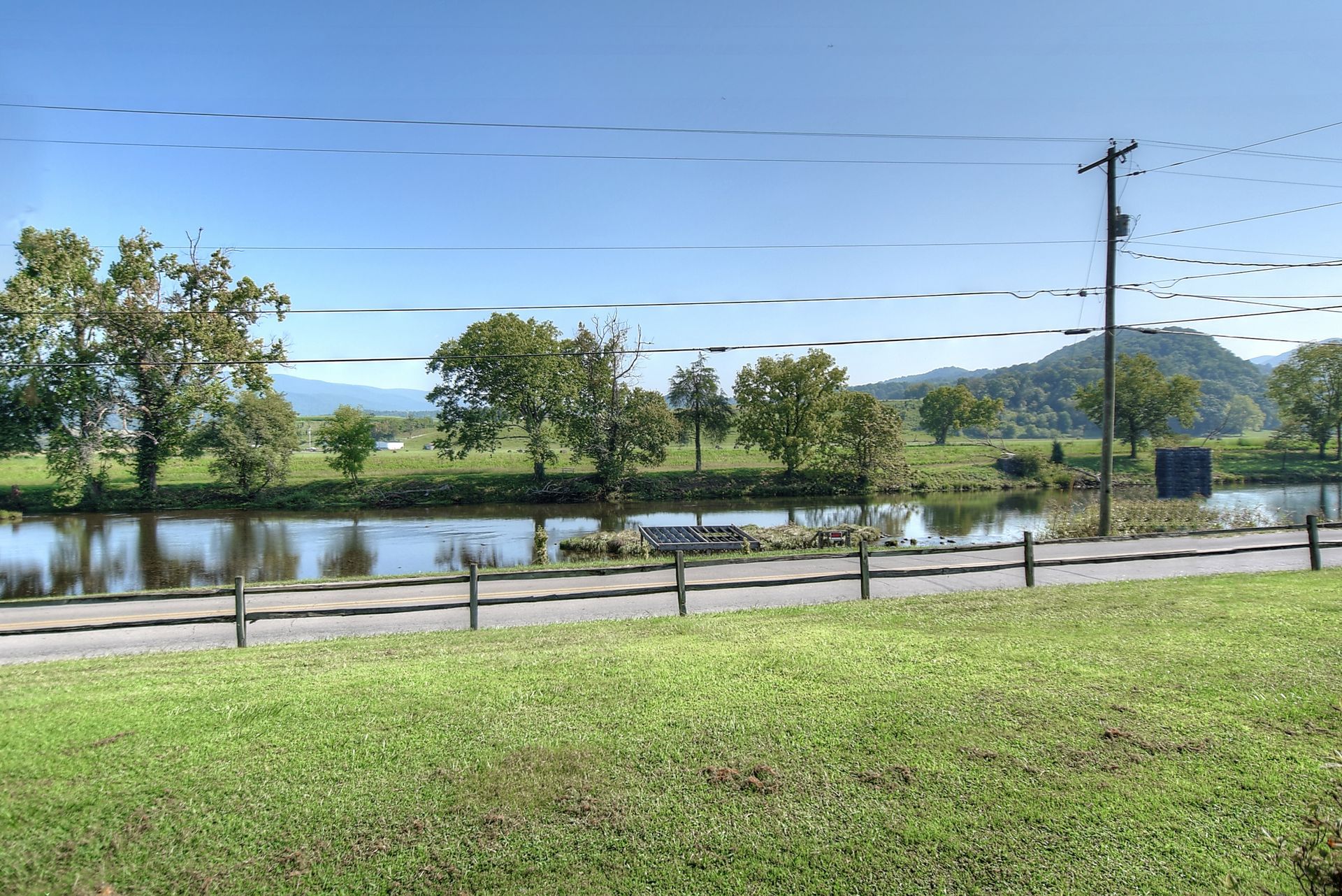 There is a lake in the middle of a grassy field.