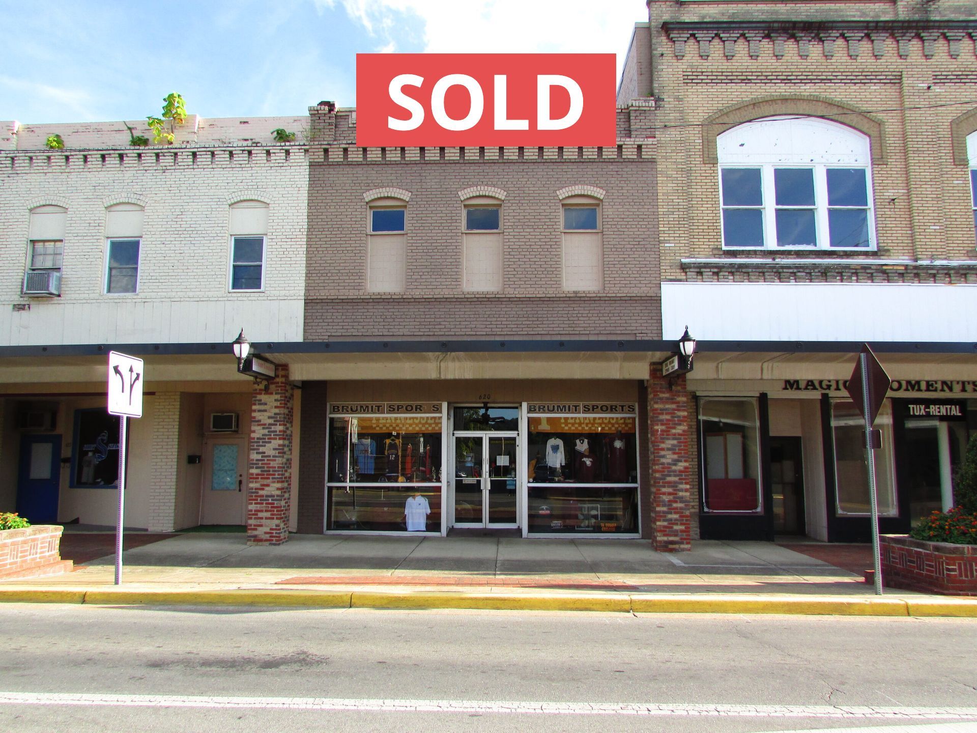 A sold sign is on the side of a building