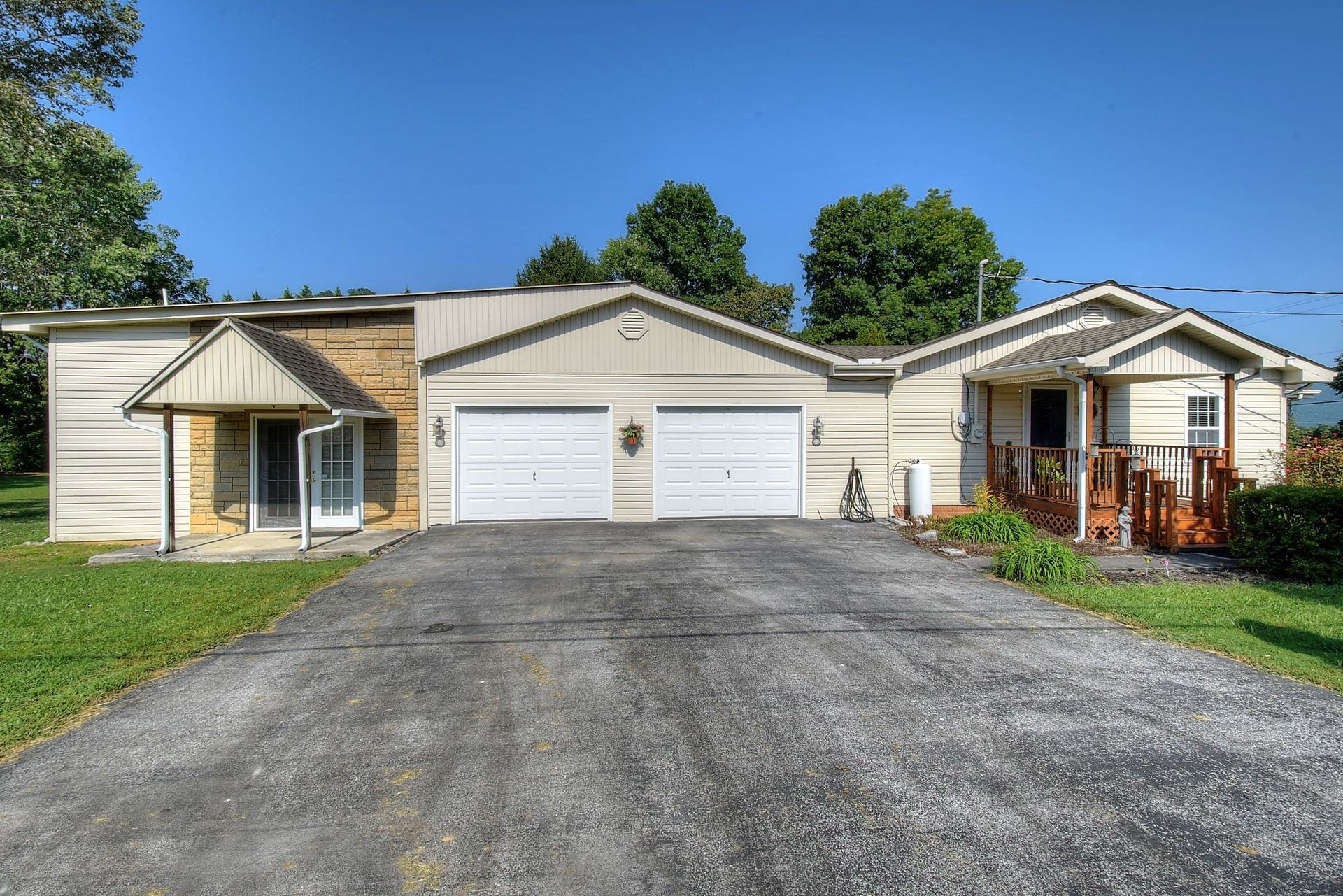 A house with two garages and a driveway in front of it