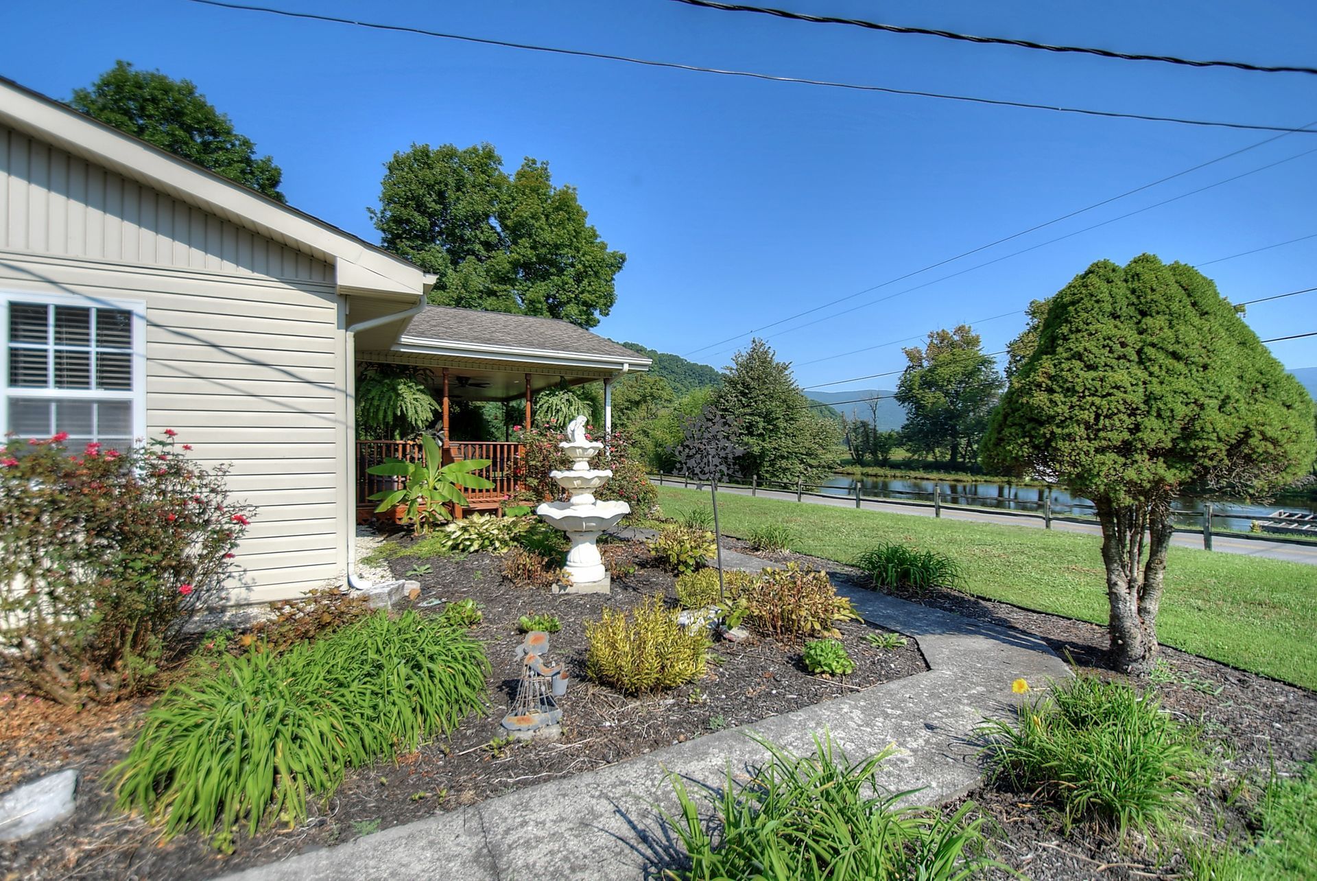 A small house with a fountain in front of it