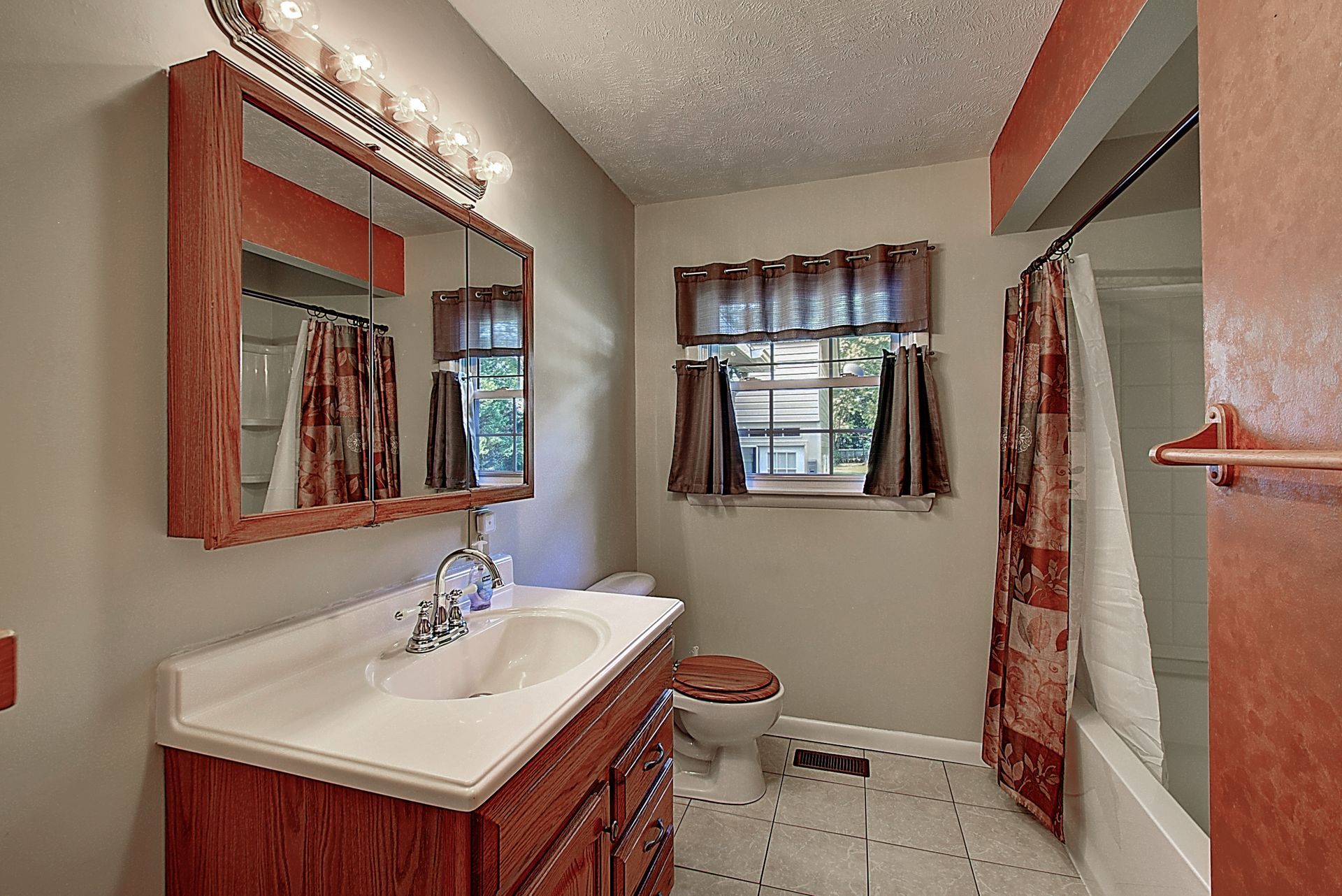 An empty bedroom with hardwood floors and a ceiling fan