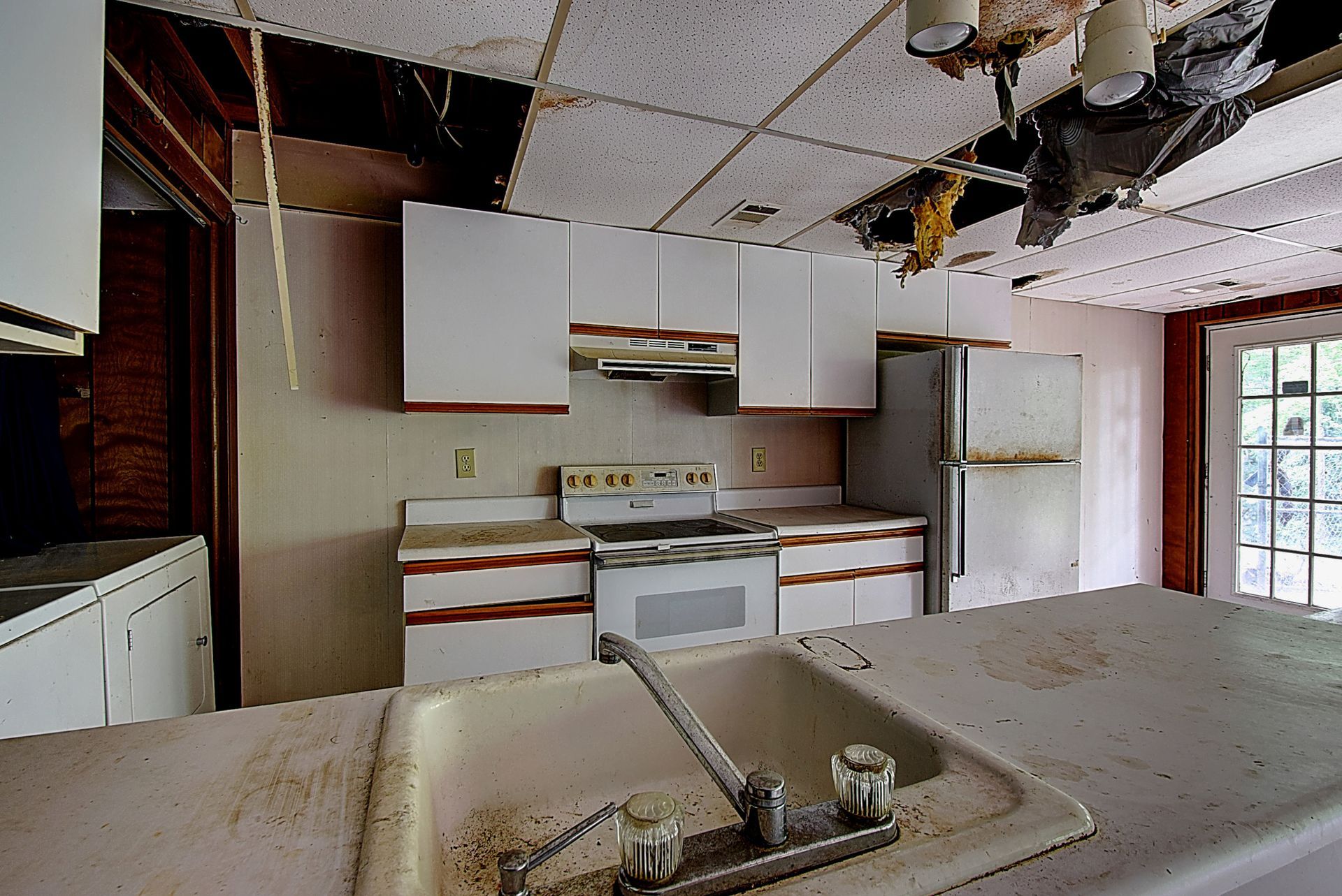 A kitchen with a sink stove and refrigerator in it