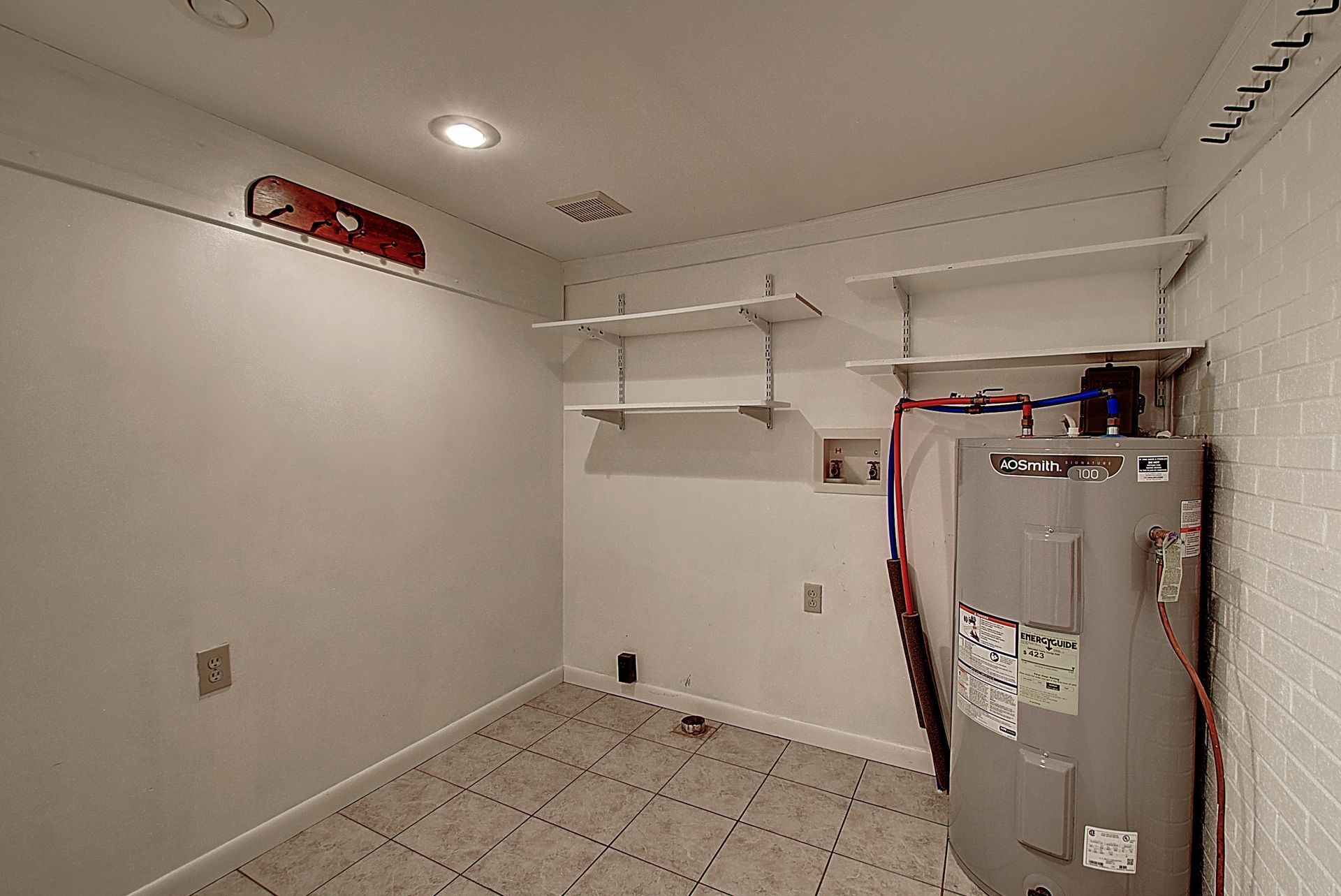 There is a water heater in the middle of the room.