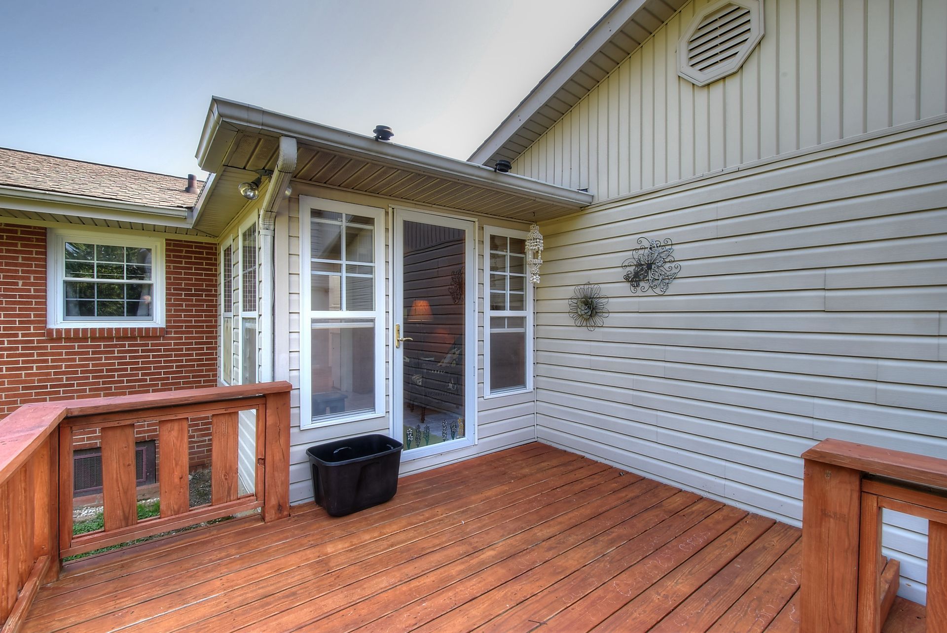 A house with a wooden deck and a screened in porch