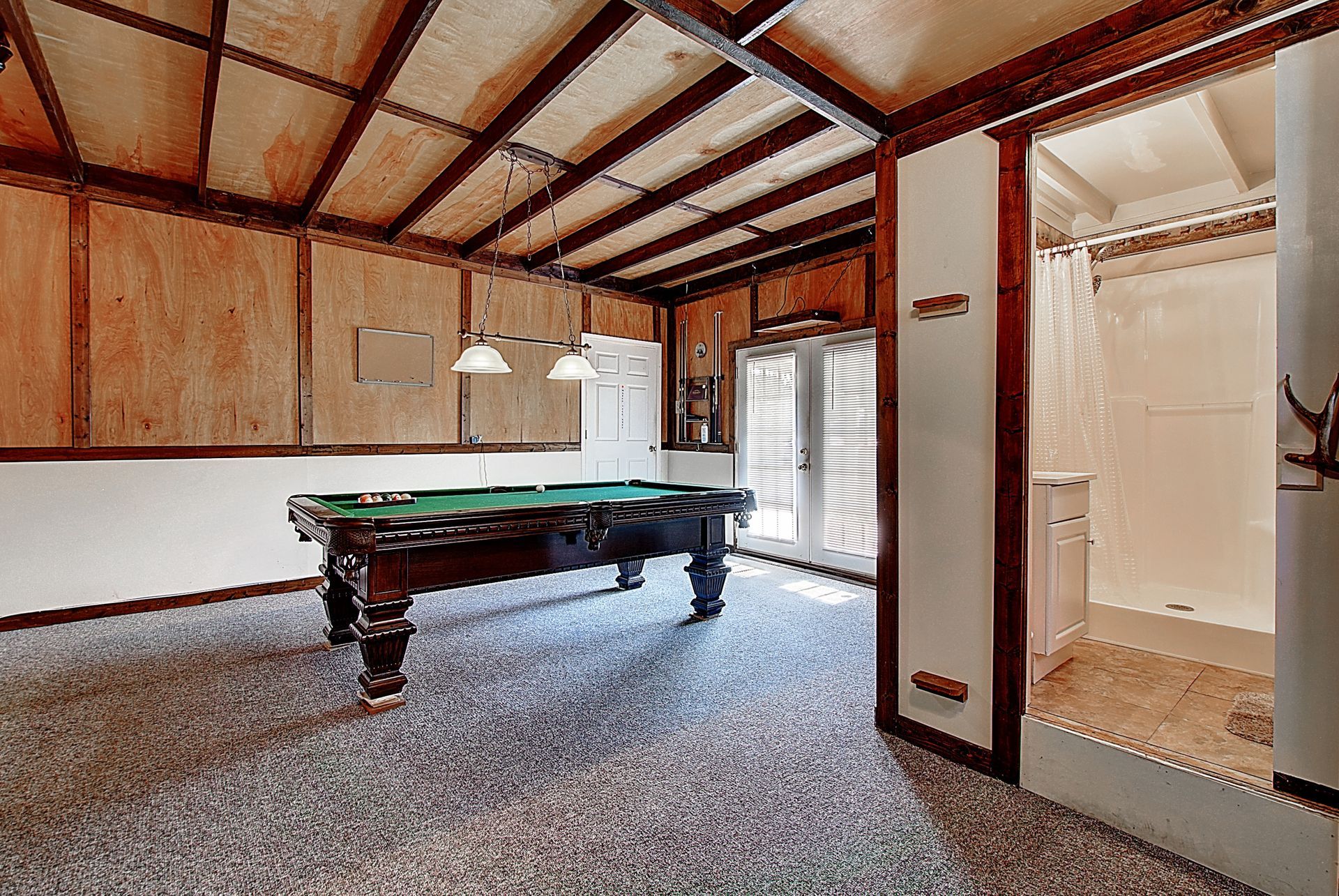 There is a pool table in the middle of the room.