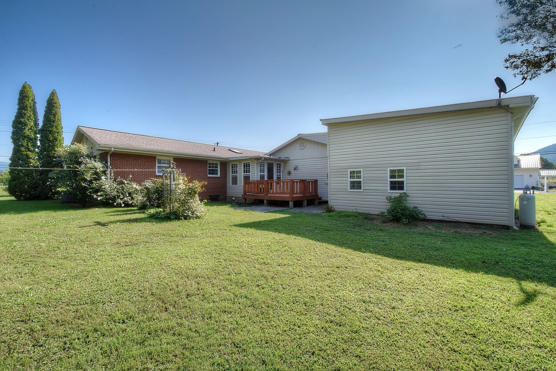 A house with a large lawn in front of it