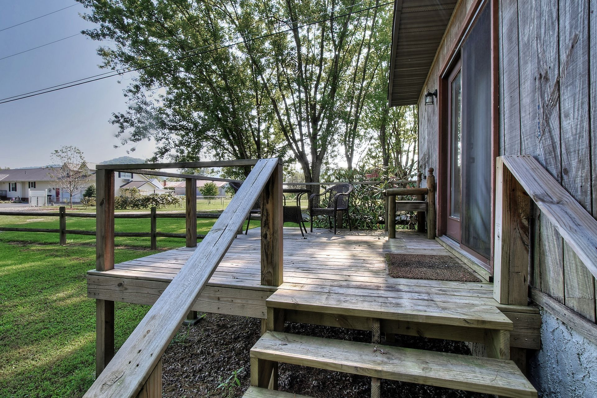 A wooden deck with stairs leading up to it