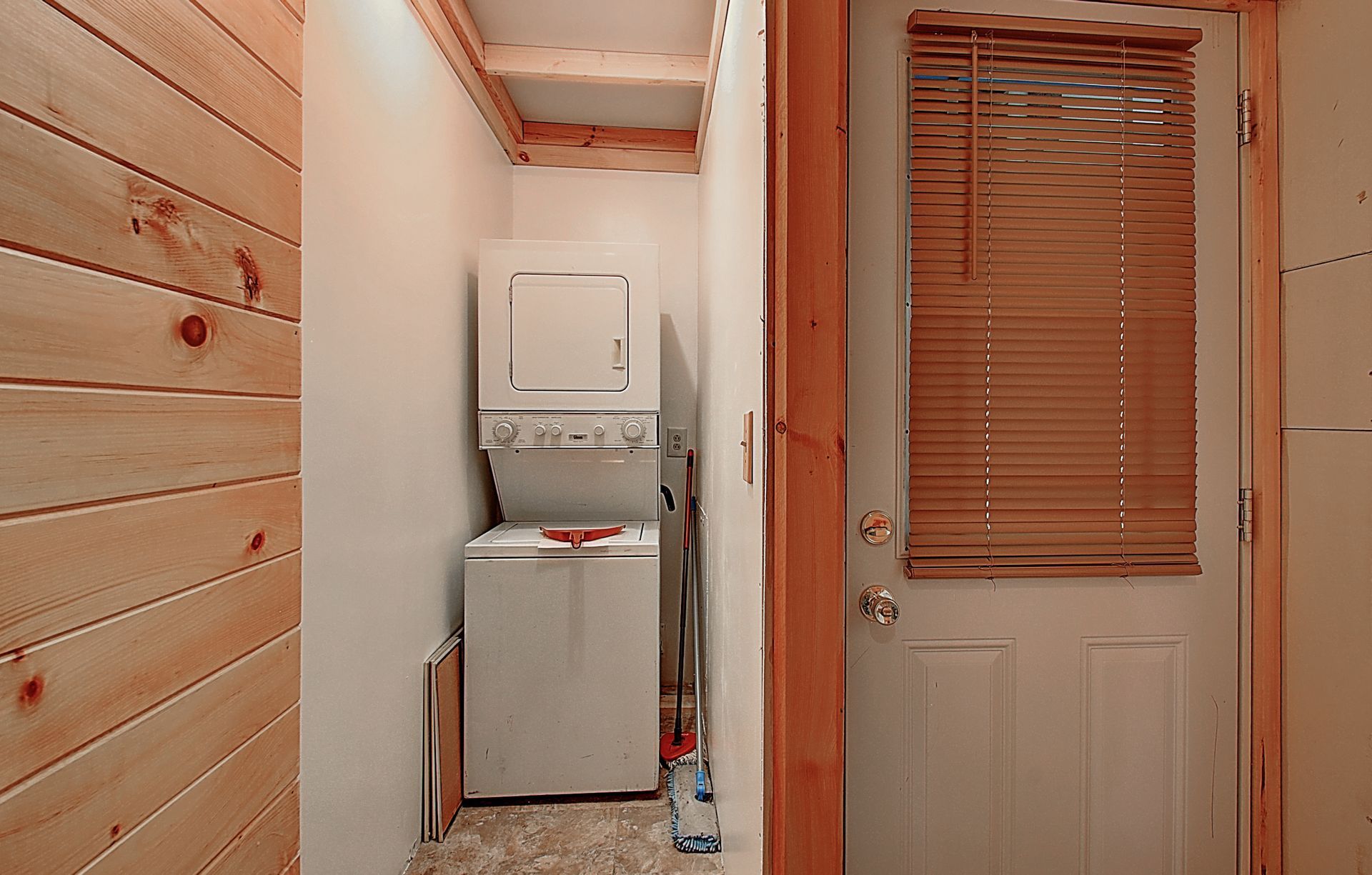 A laundry room with a washer and dryer stacked on top of each other.