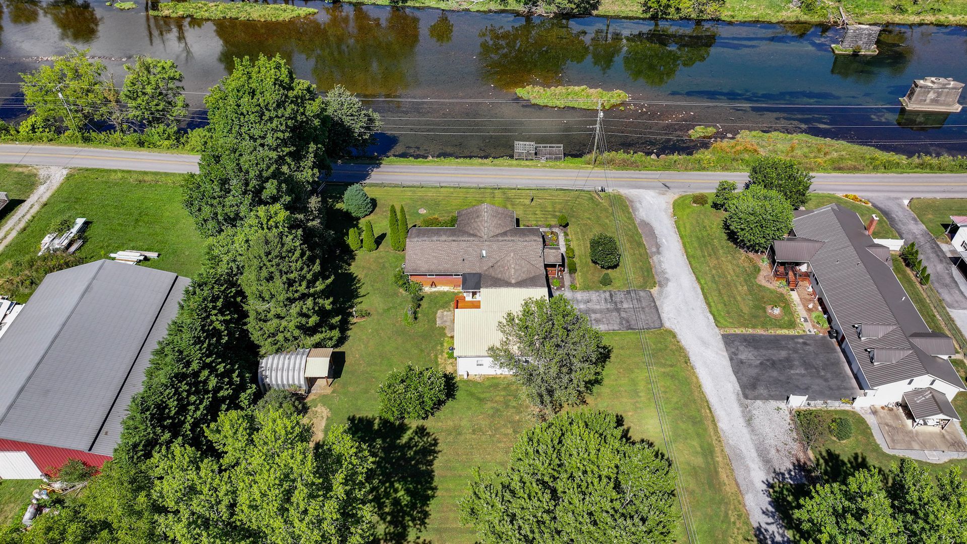 An aerial view of a residential area with a river in the background at 238 Wilbur Dam Rd Elizabethton Tennessee.
