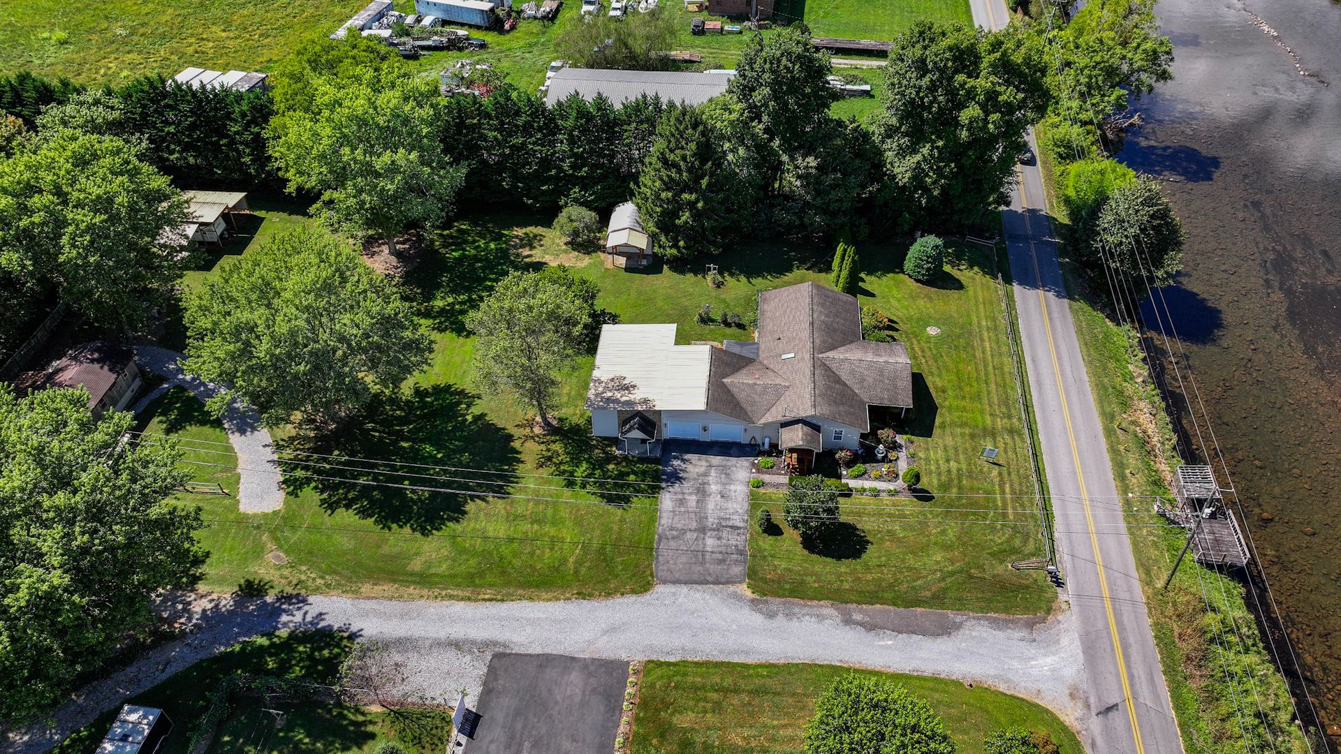 An aerial view of a house surrounded by trees and grass at 238 Wilbur Dam Rd Elizabethton Tennessee.