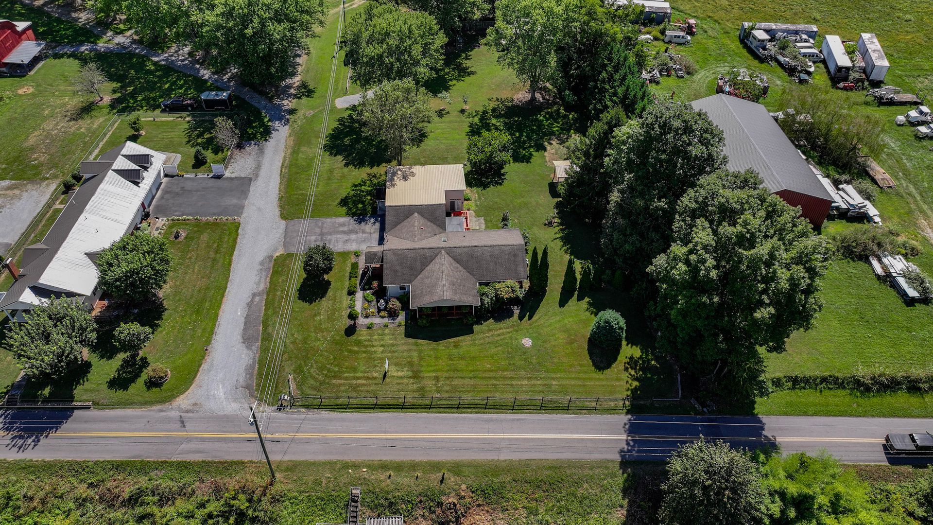 An aerial view of a house surrounded by trees and a road at 238 Wilbur Dam Rd Elizabethton Tennessee.
