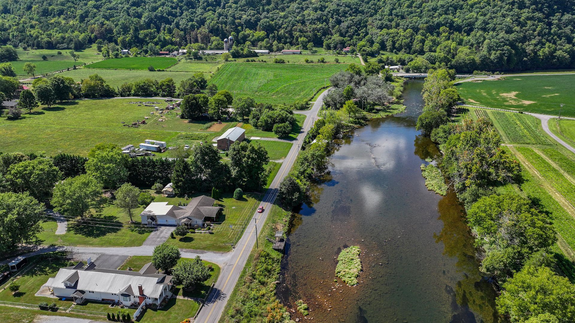 An aerial view of a river surrounded by trees and houses at 238 Wilbur Dam Rd Elizabethton Tennessee.