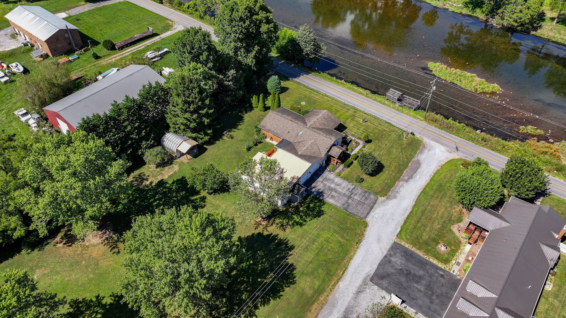 An aerial view of a residential area with a river in the background at 238 Wilbur Dam Rd Elizabethton Tennessee.