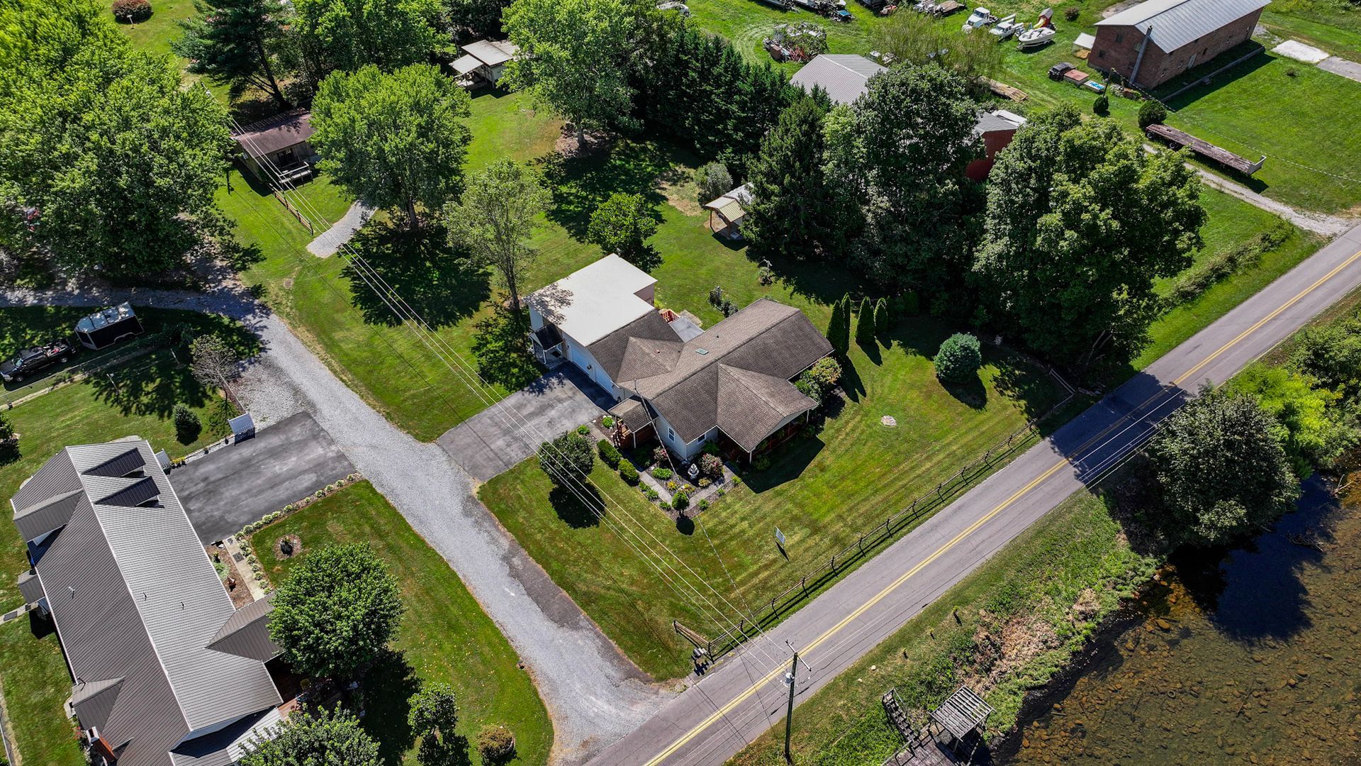 An aerial view of a residential area with lots of houses and trees at 238 Wilbur Dam Rd Elizabethton Tennessee.
