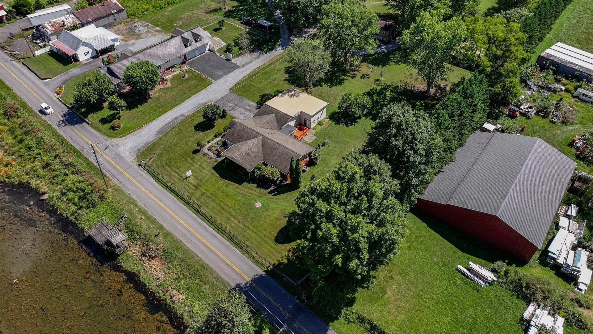 An aerial view of a residential area with houses and a road at 238 Wilbur Dam Rd Elizabethton Tennessee.