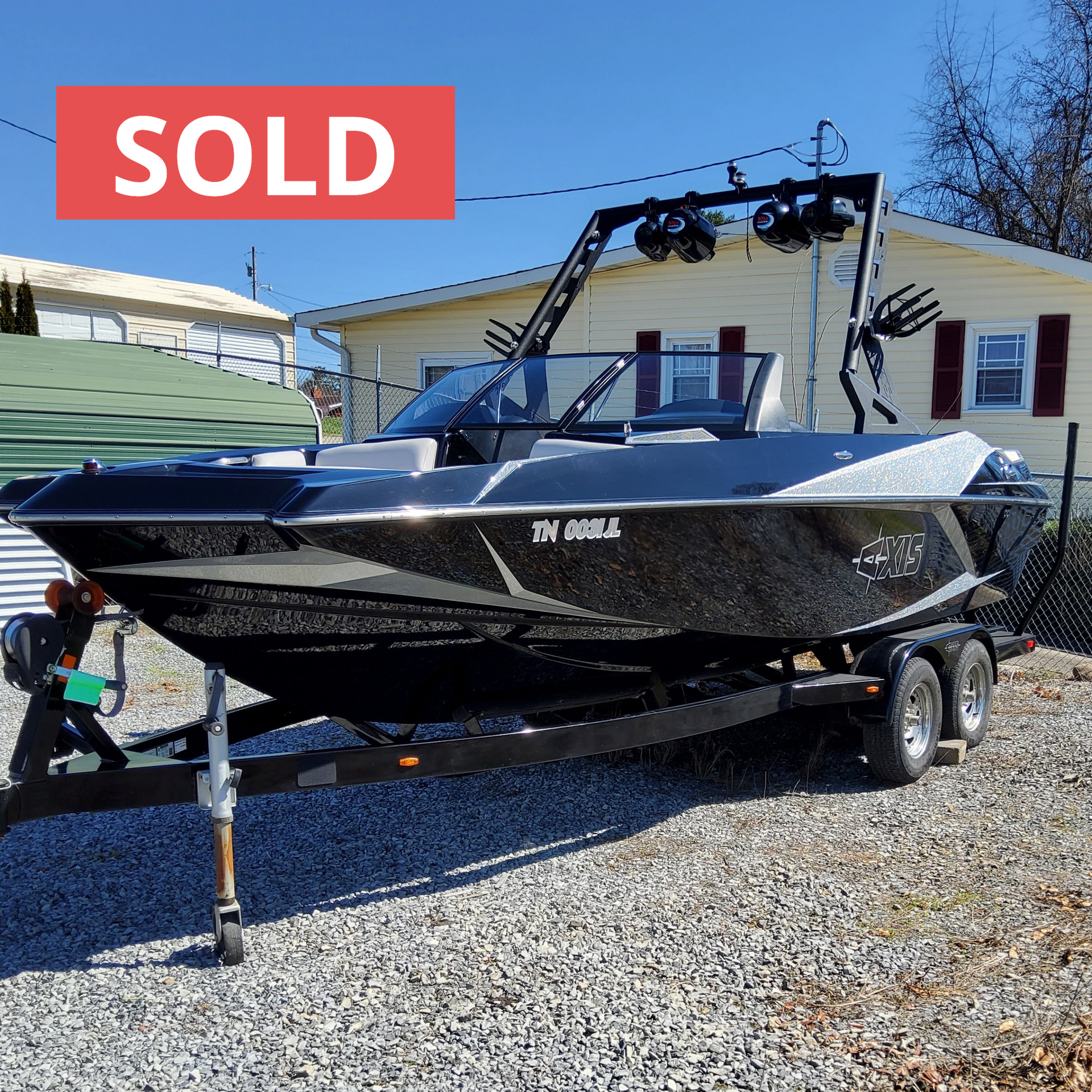 A boat on a trailer that has the word sold on it