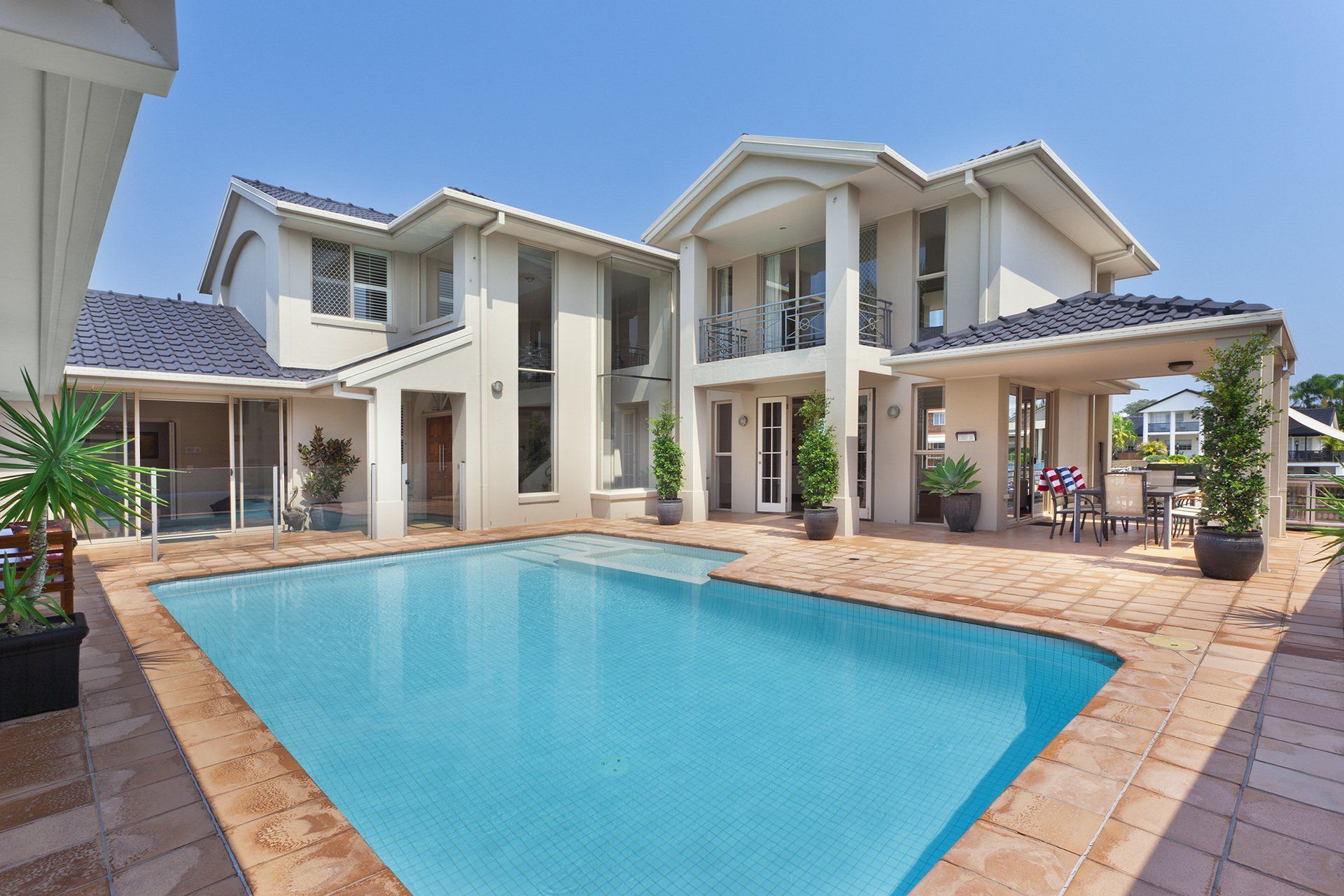 A large house with a large swimming pool in front of it