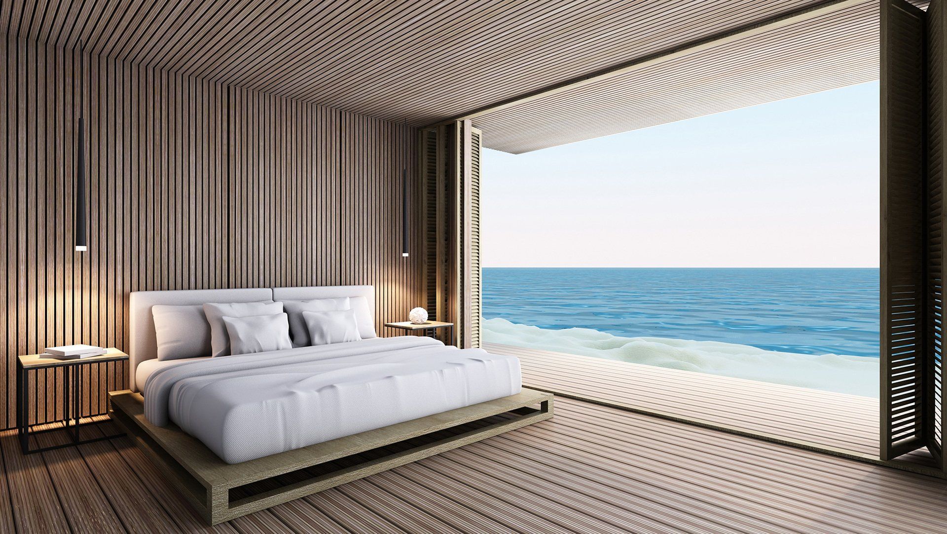 A bedroom with a large bed and a view of the ocean.