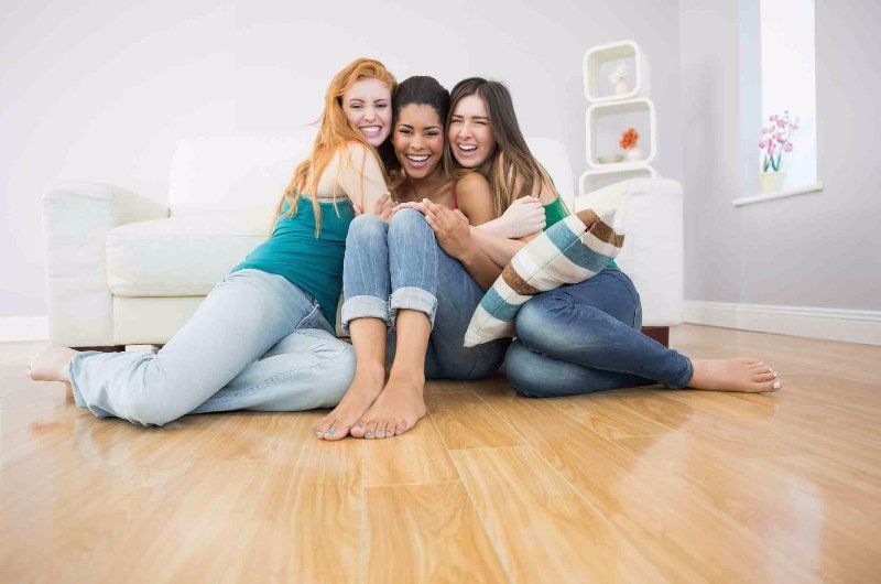 girls sitting on a wooden floor