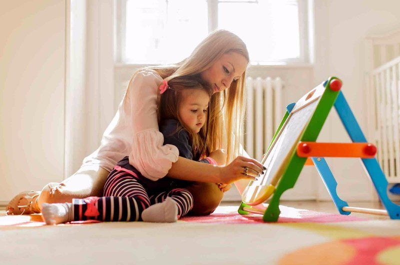 mom and child sitting on a floor