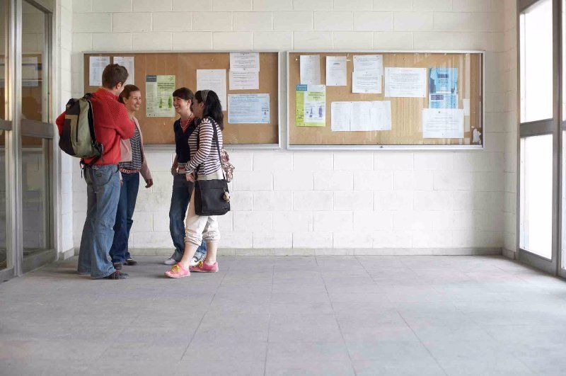 students standing on a tiled floor