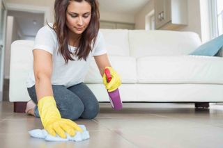 woman cleaning a tiled floor